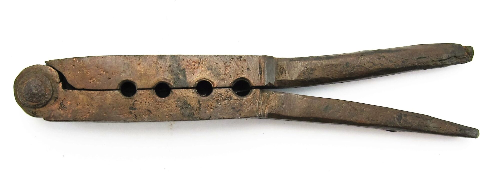 A Civil War Era Bullet Gang Mold with four cavities and two handles, displaying a vintage, rusted metal look, is shown against a white background.