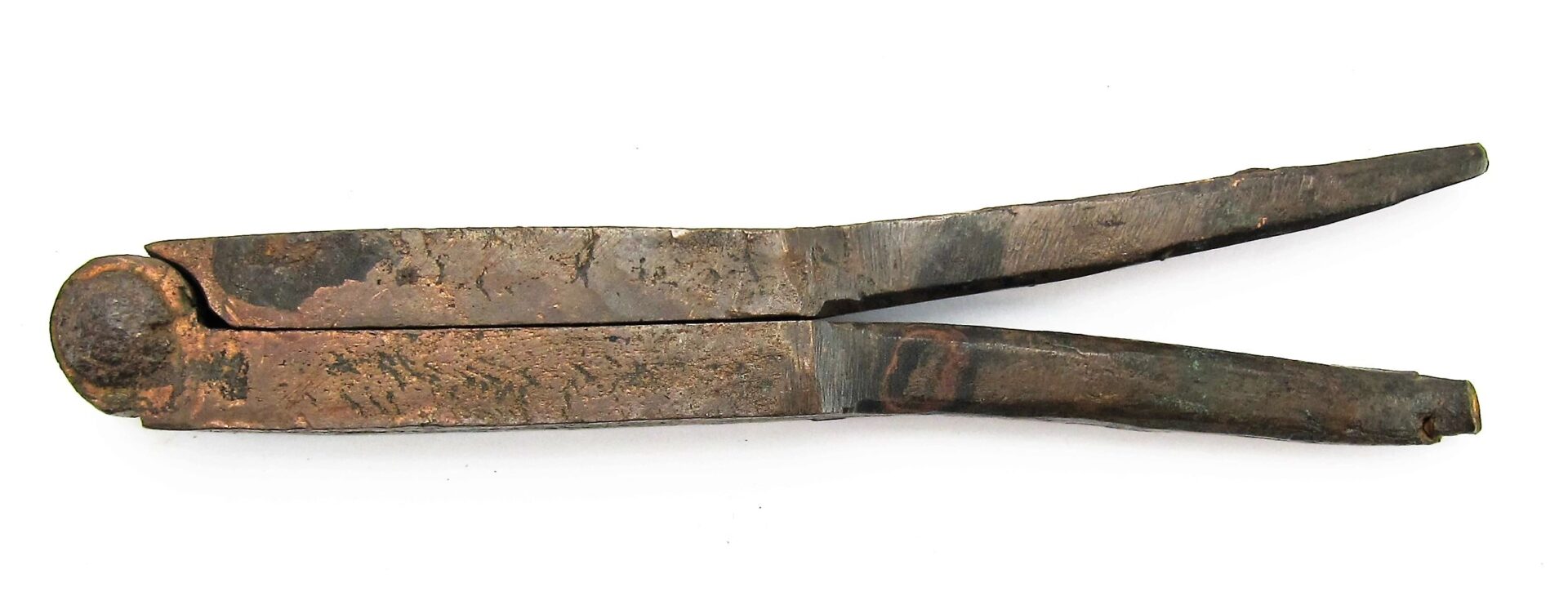 A Civil War era bullet gang mold with a simple, worn metal design is shown lying flat on a white background.
