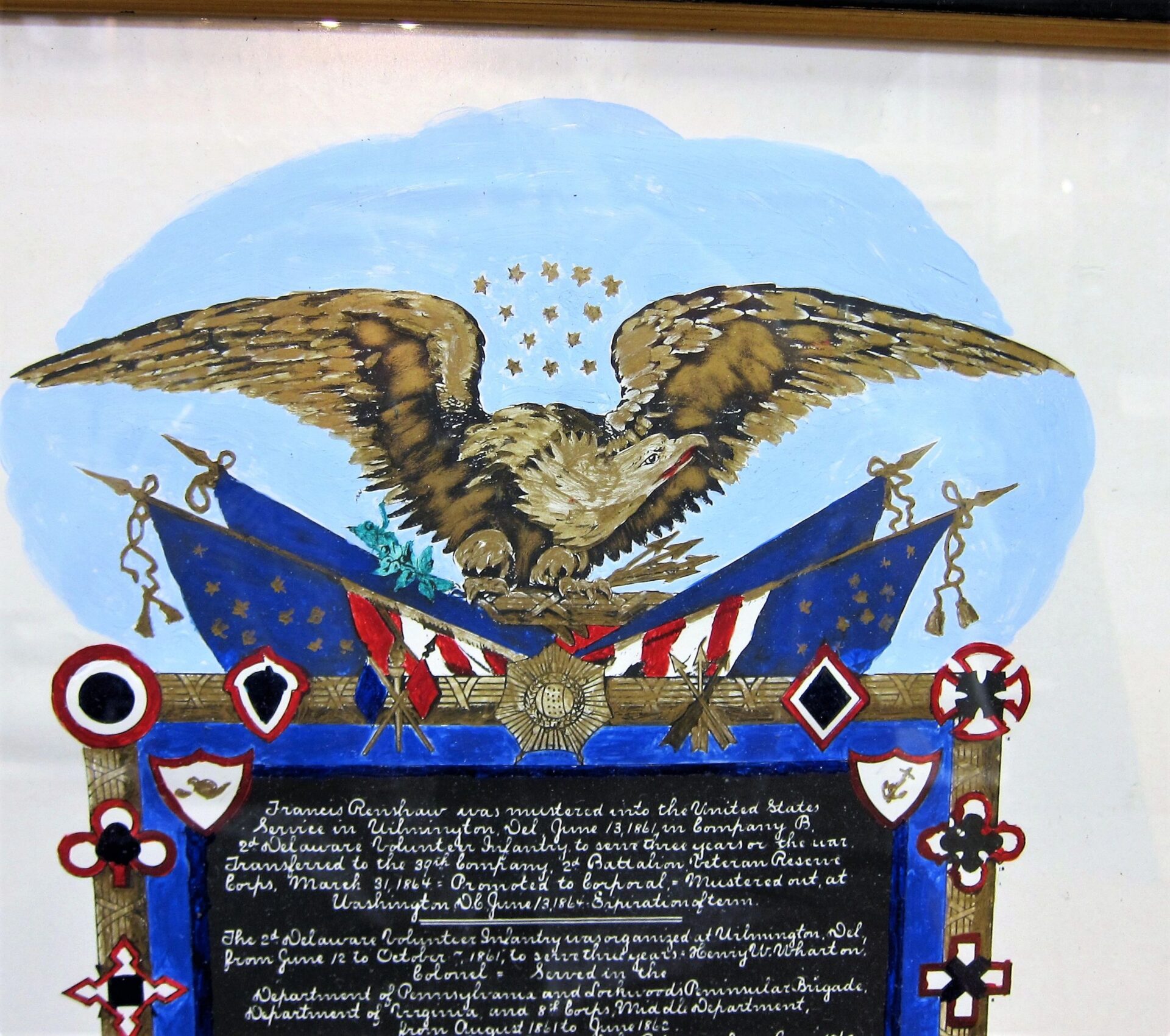 Illustration of the Military Escutcheon of Francis Renshaw, 2nd Delaware Volunteer Infantry, featuring a bald eagle with wings spread above crossed American flags and patriotic symbols, with a decorative plaque beneath. Sold.