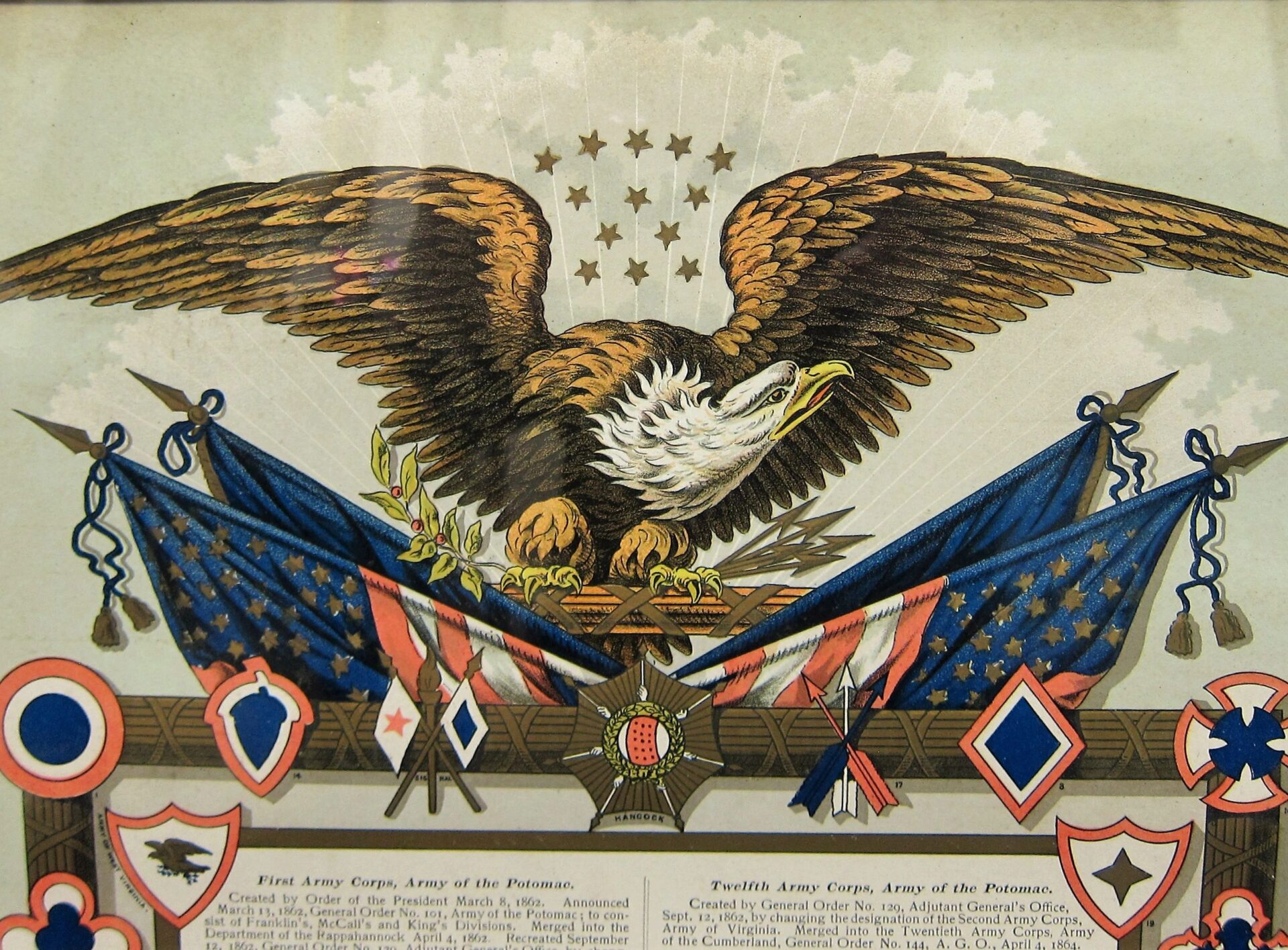 The US Army Corp Escutcheon features an eagle with outstretched wings above crossed American flags, military badges, medals, and a cluster of stars in the background.