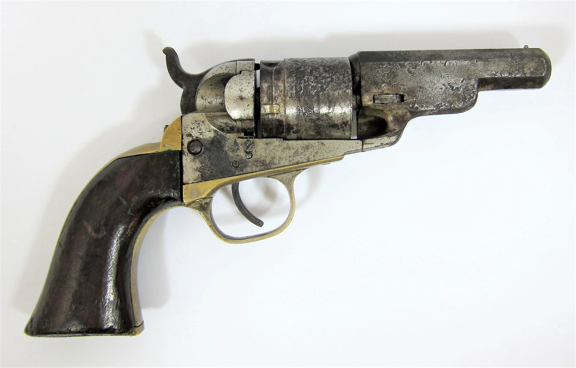 A Colt Wells Fargo Conversion revolver with a dark wooden grip and metal barrel, shown against a plain white background.