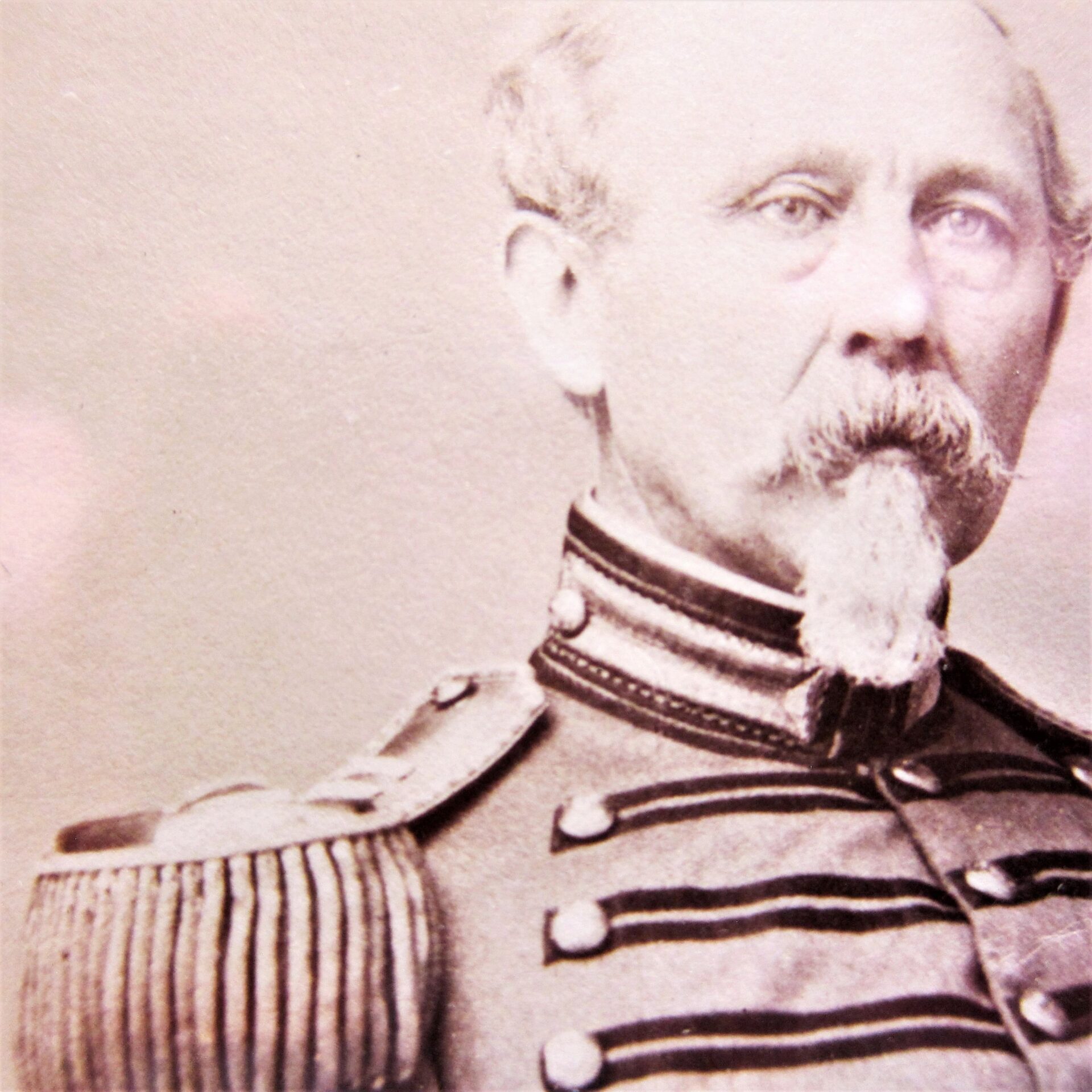 A sepia-toned albumen portrait of Brevet Colonel Henry C. Shumway, Captain of the 8th Company National Guard, 7th Regiment NYSM, in decorated military uniform with epaulettes, moustache, and pointed beard, looking slightly away.