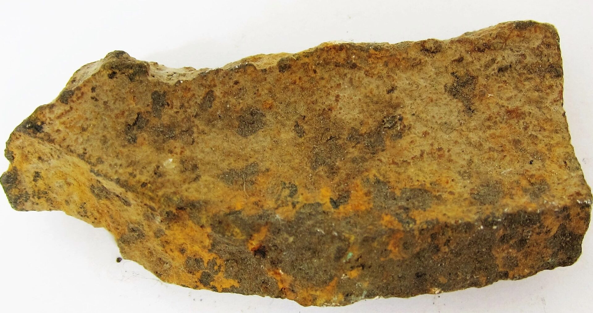 A rough, irregularly shaped Gettysburg Shell Fragment with a brownish surface, visible texture, and small rust-colored patches is shown on a white background.