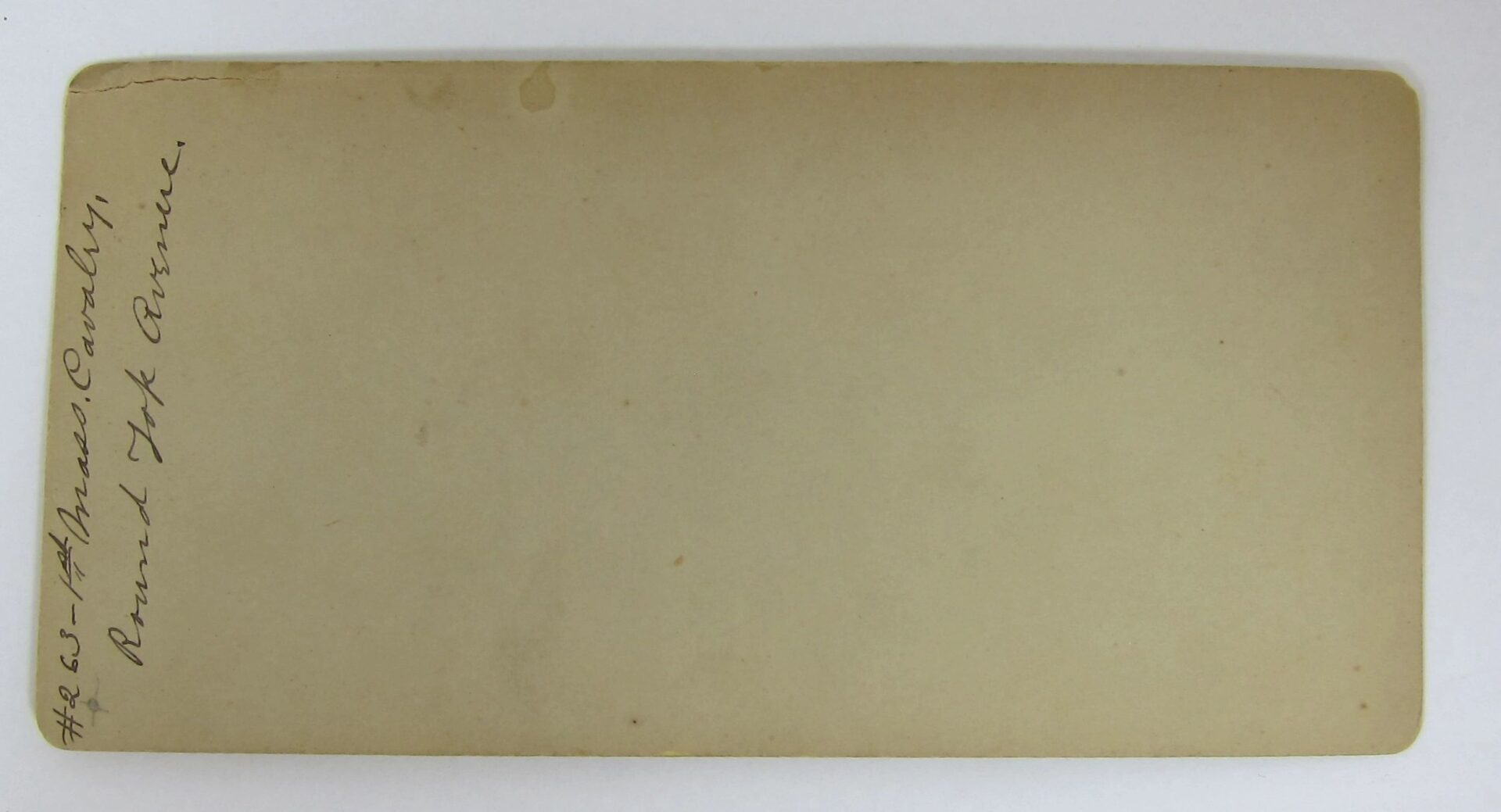 A worn, beige postcard with handwritten text along the left edge reads, "1st Mass. Cavalry Monument - Gettysburg.