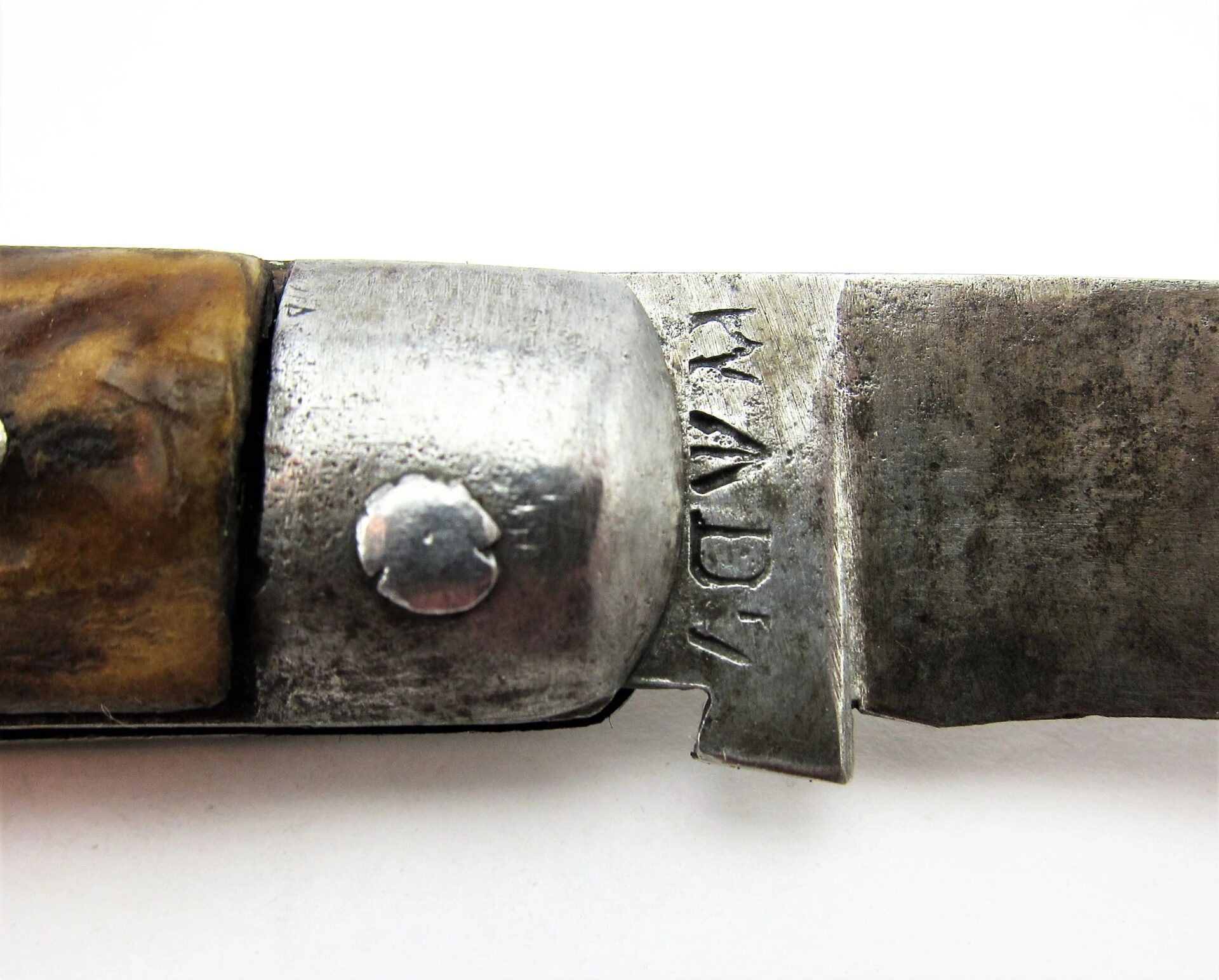 Close-up of a Rare Civil War Era Navy Sailor's Working Pocket Knife, showing the metal hinge and "MADE" stamped at the base of the blade.
