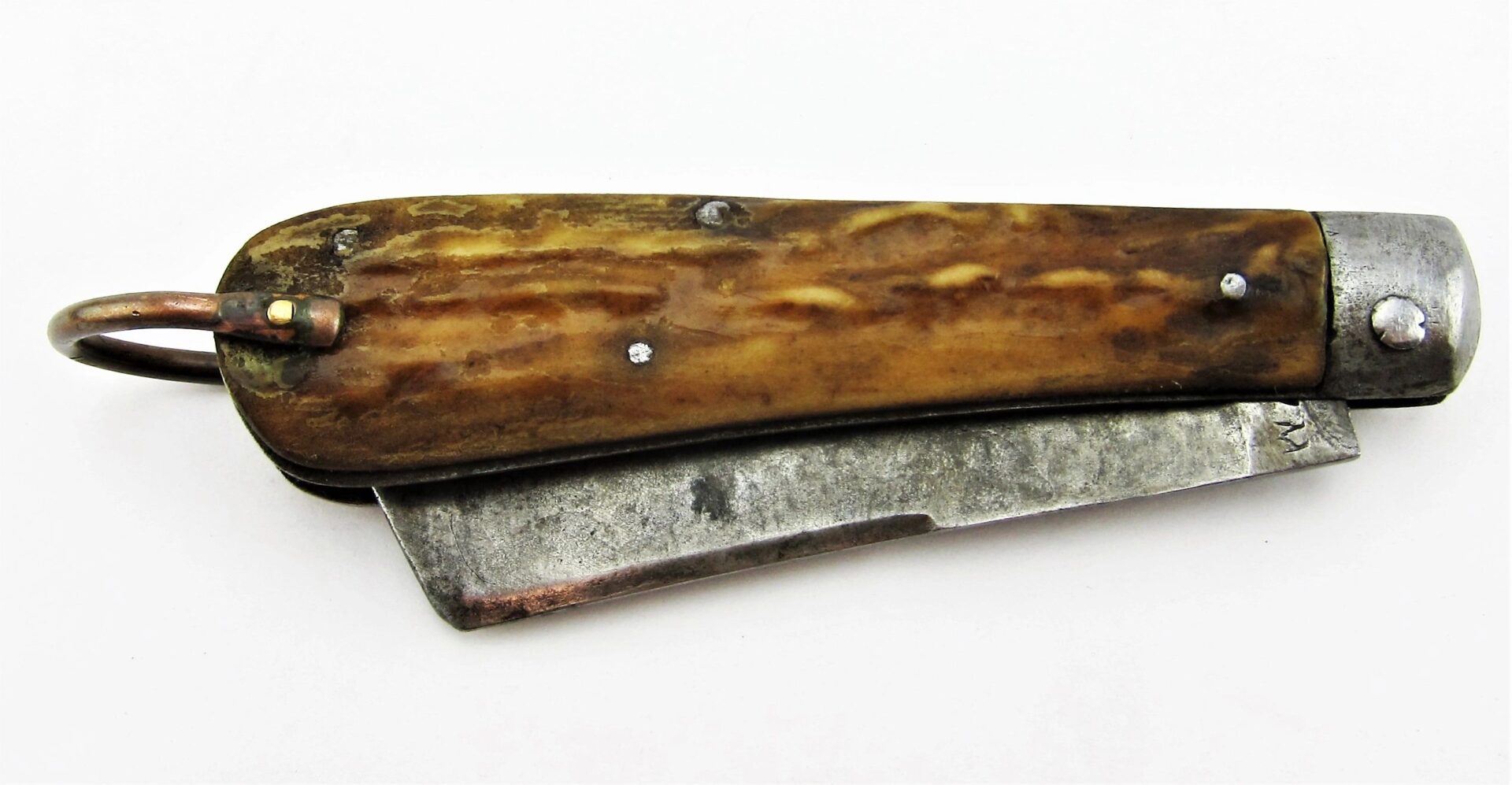 A Rare Civil War Era Navy Sailor's Working Pocket Knife with a brown textured handle and worn metal blade, shown closed on a white surface. / SOLD.
