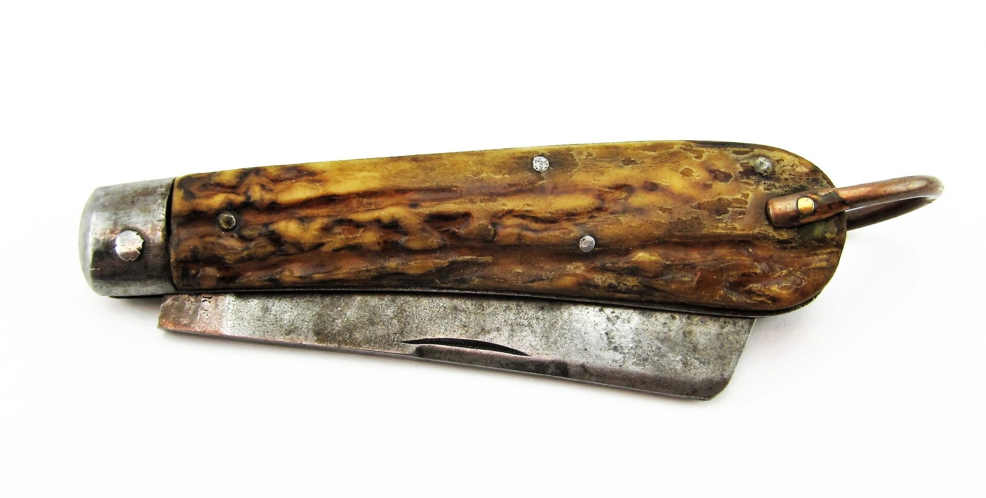 A Rare Civil War Era Navy Sailor's Working Pocket Knife, featuring a worn textured handle and partially extended blade, displayed on a white background. / SOLD.