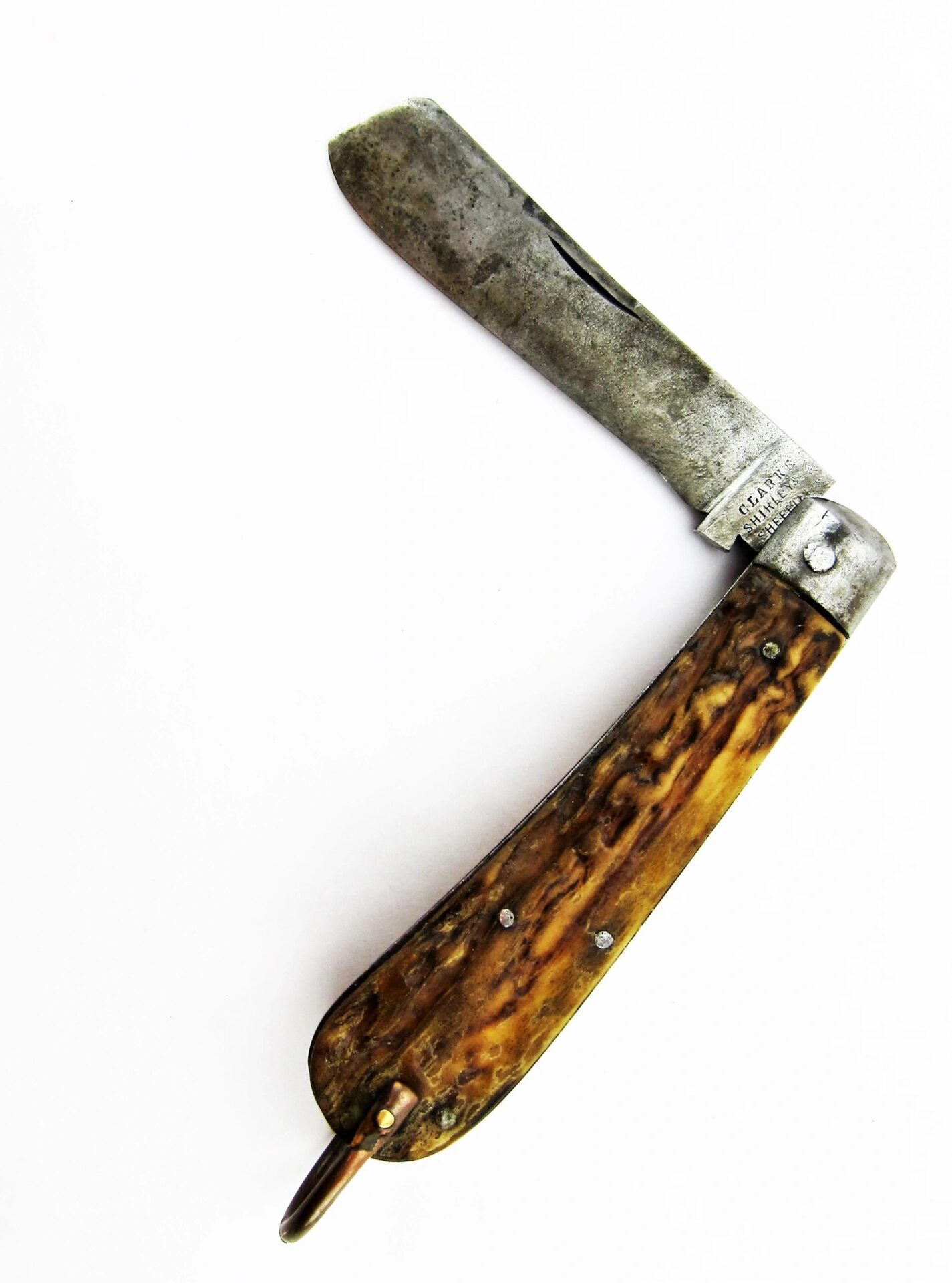 A Rare Civil War Era Navy Sailor's Working Pocket Knife, featuring a tarnished metal blade and textured brown handle, is partially open against a white background. / SOLD.