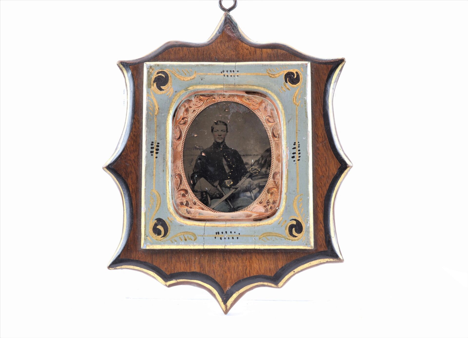 The Cavlary Image is a vintage photograph of a person in uniform, set in an ornate, multi-colored wooden frame with decorative patterns.
