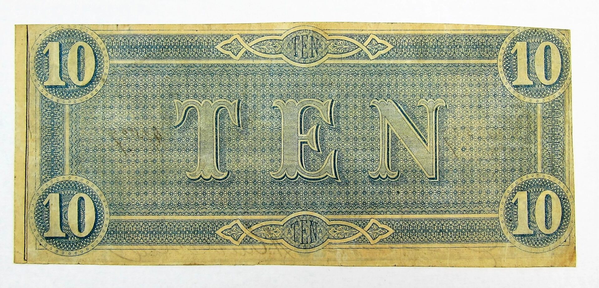 The Confederate Currency Ten Dollar Note features the word "TEN" prominently at the center and the number "10" in circles at each corner on a patterned background.