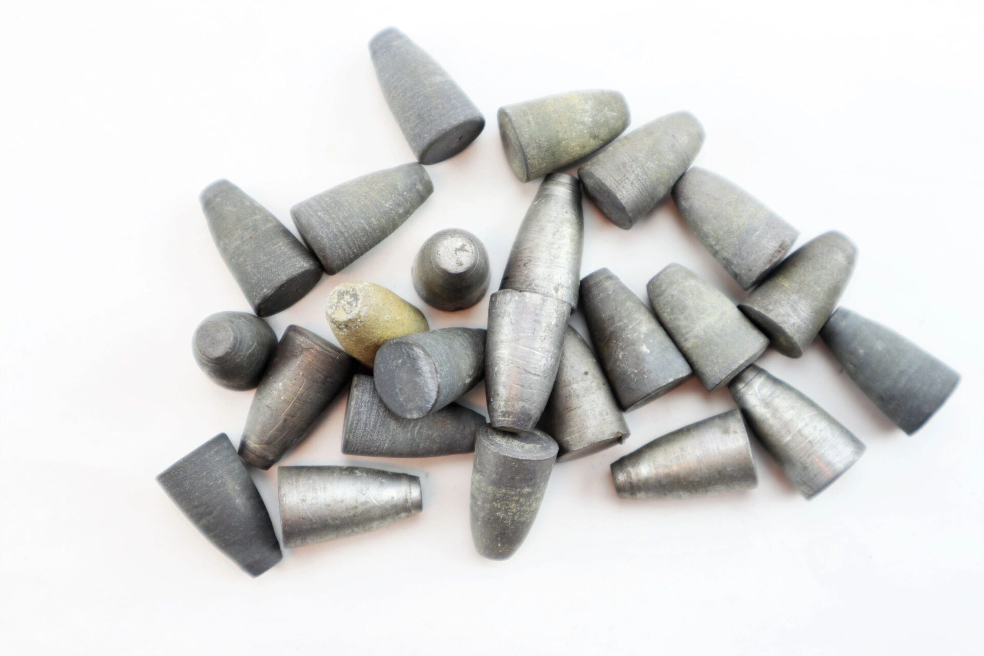 A display of "Target Rifle" Box Sharpshooters (SOLD) featuring gray cylindrical lead sinkers with conical ends scattered on a white background.