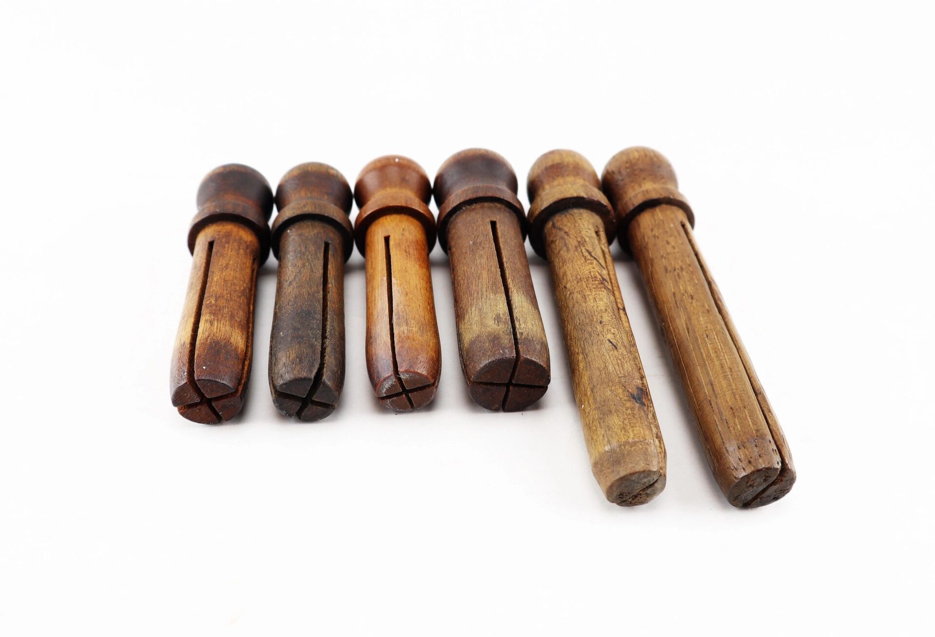 Five Civil War Musket Tompions with a vintage look are arranged in a row on a white background.