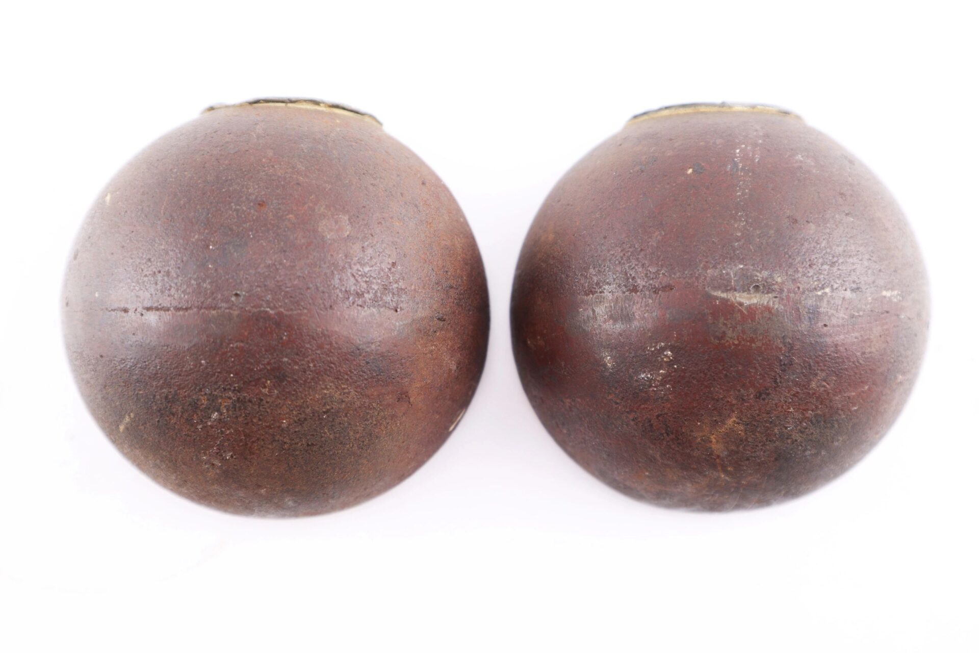 Two vintage Confederate 6 Pound Borman artillery shells with visible wear and textured surfaces, displayed side by side on a white background.