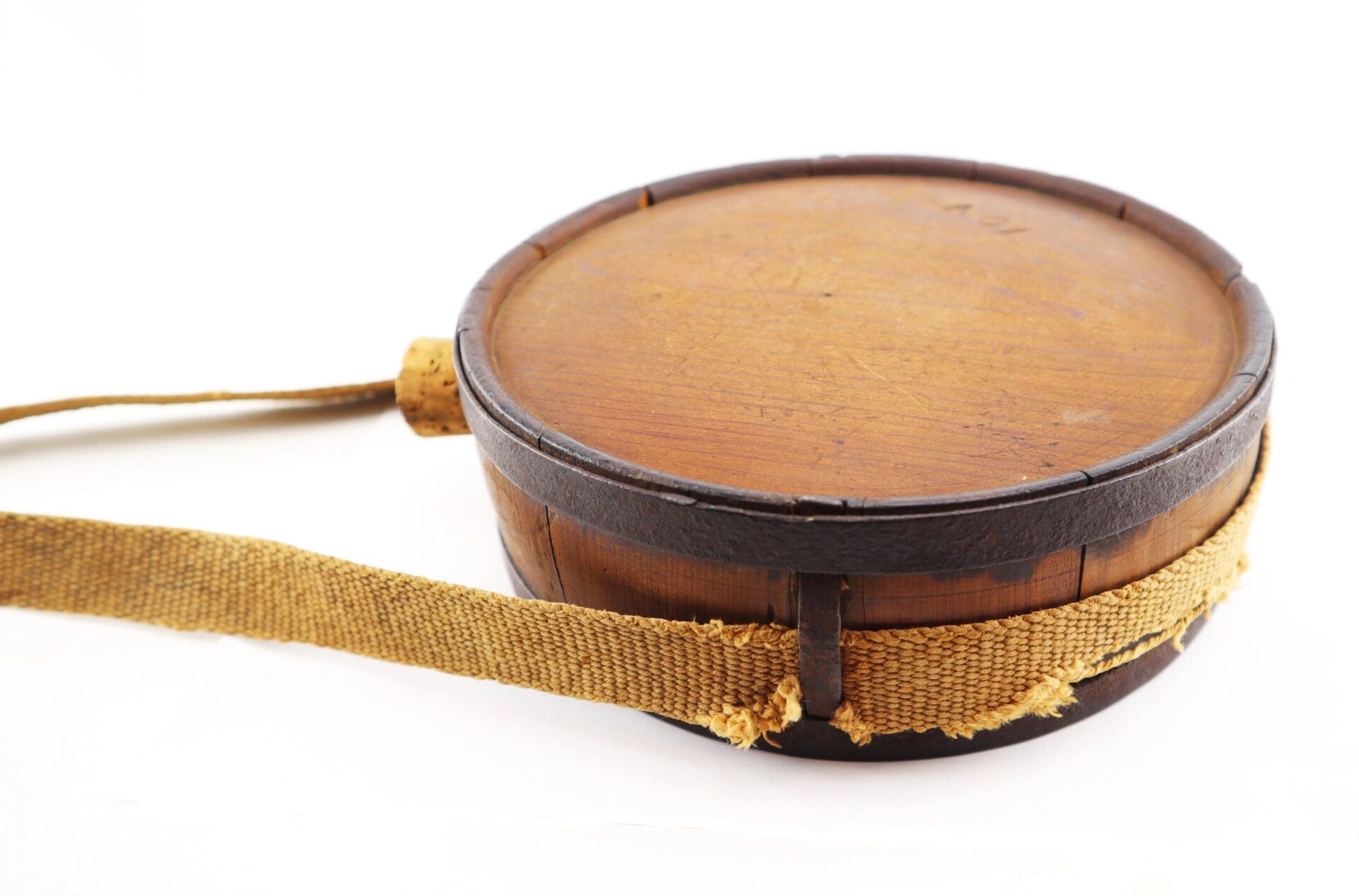 A Confederate Wood Drum Canteen with a lid and frayed fabric shoulder strap is shown on a white background. / SOLD.