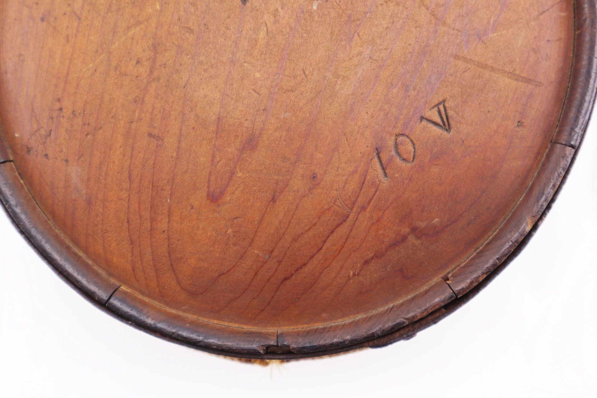 Close-up of a Confederate Wood Drum Canteen with a dark rim and "10V" etched into its round wooden surface.