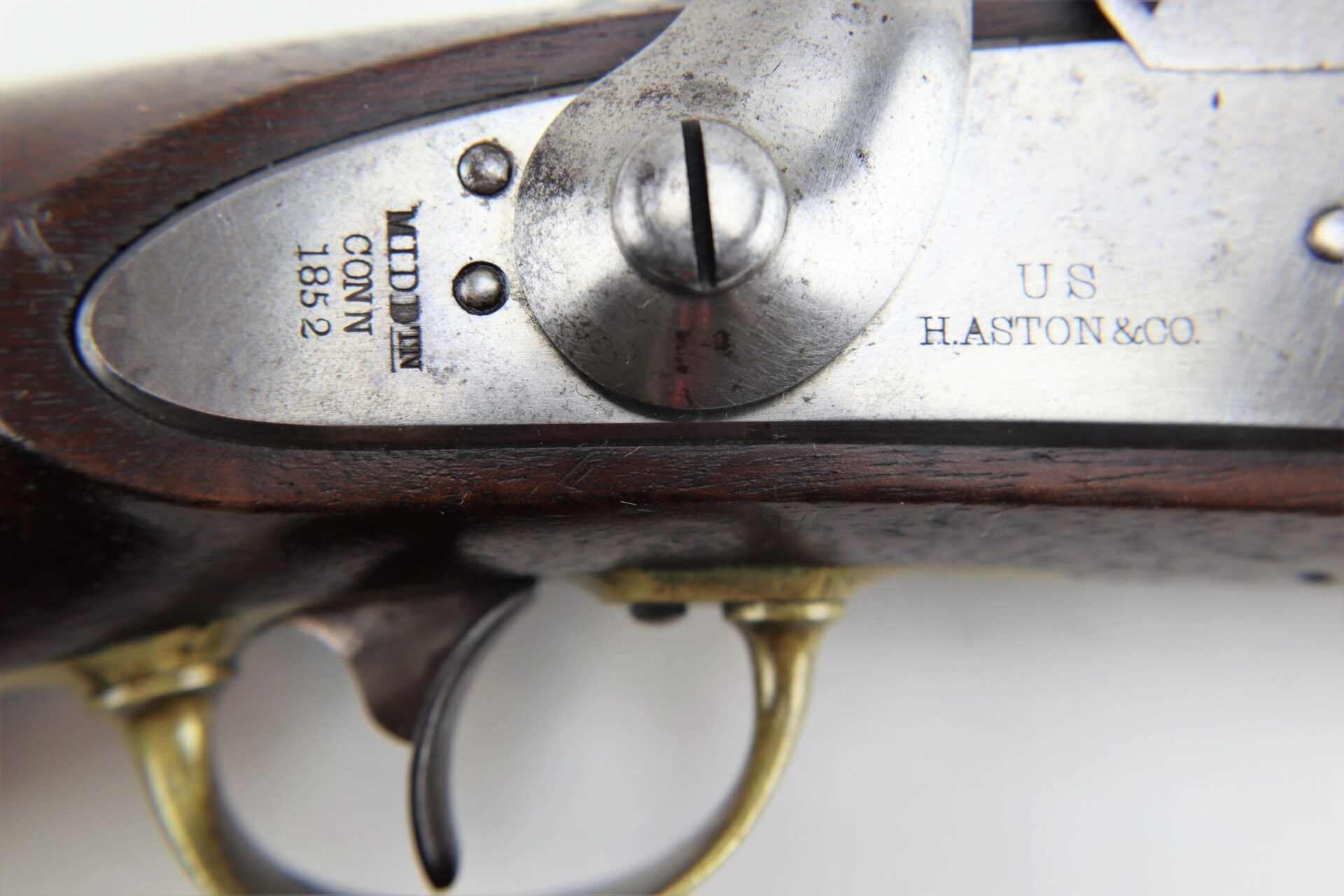 Close-up of the Aston Horse Pistol, featuring its trigger, wooden stock, and metal plate engraved with "US H. ASTON & CO." and "MIDDtn CONN 1852". This antique firearm is marked as SOLD.