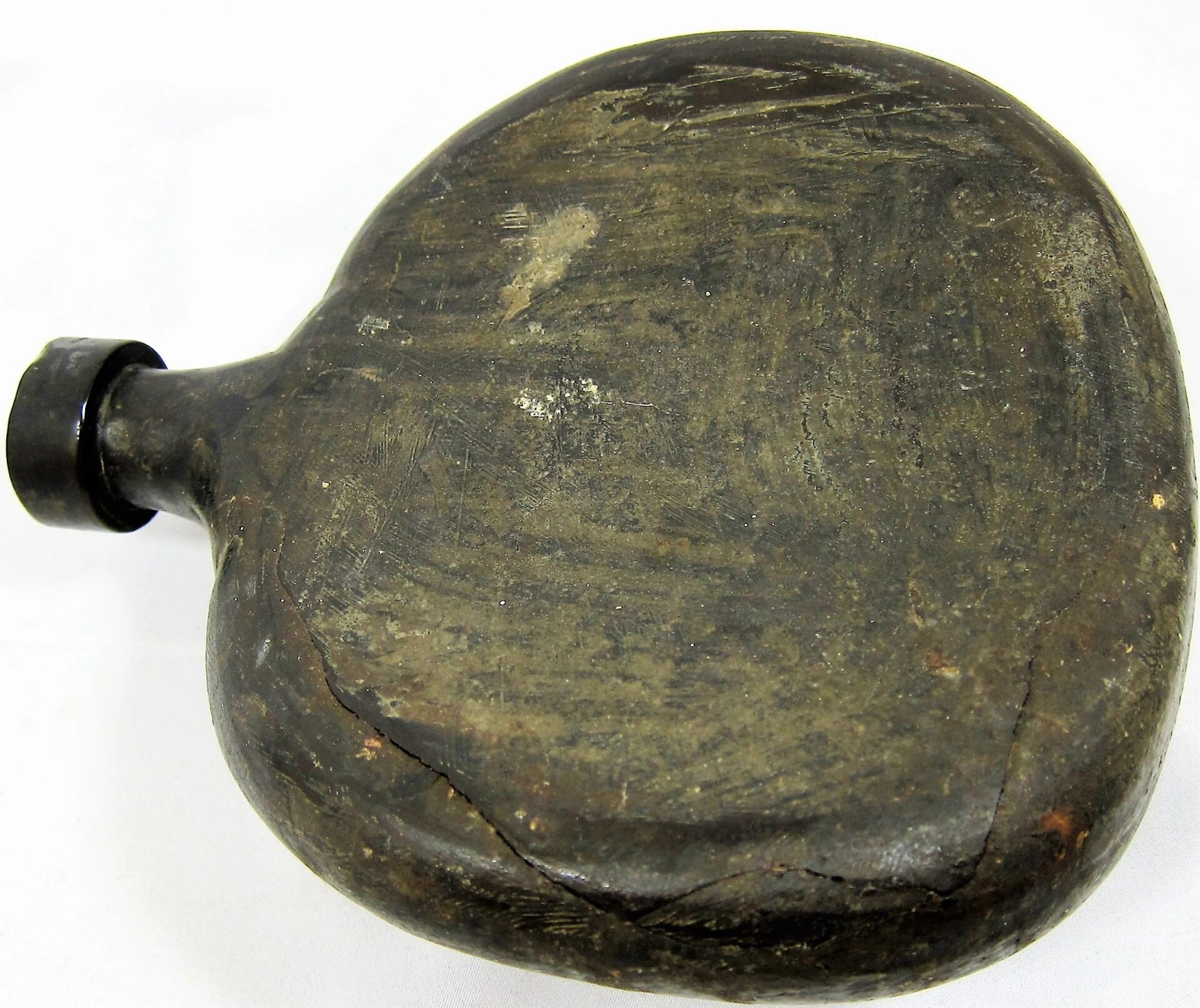 Civil War Era Gutta-Percha Canteen / SOLD—an oval, dark canteen with a narrow neck and visible surface scratches and cracks, shown against a white background.