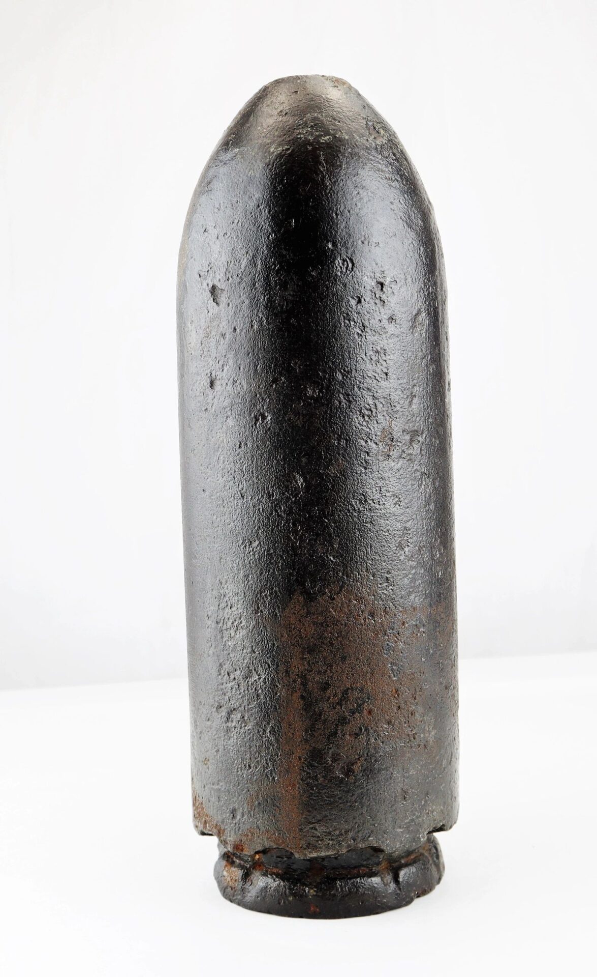 A US 4.2" 30-Pounder Parrott Common Shell, large and cylindrical with a rusted surface, stands upright against a plain white background.
