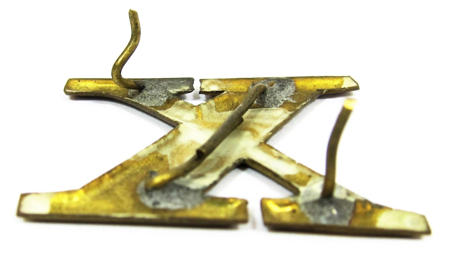 The Regimental Company Letter X is a metal letter "X" featuring three bent mounting pins on the back, with visible signs of soldering and wear.