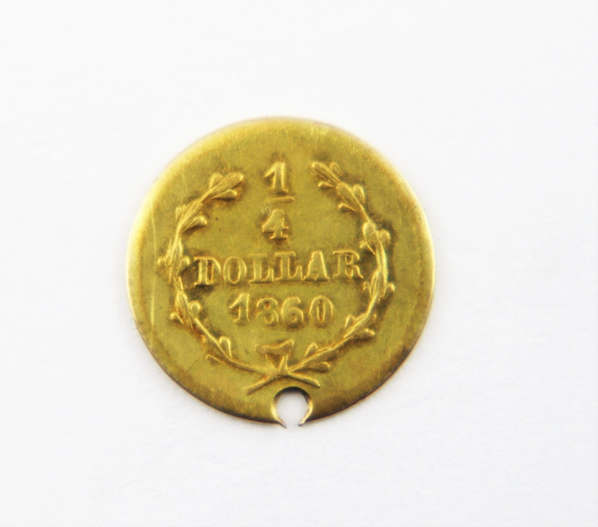 A 1860 Quarter Dollar Gold Coin, marked "1/4 DOLLAR 1860," features a laurel wreath design and a small circular notch at the bottom.