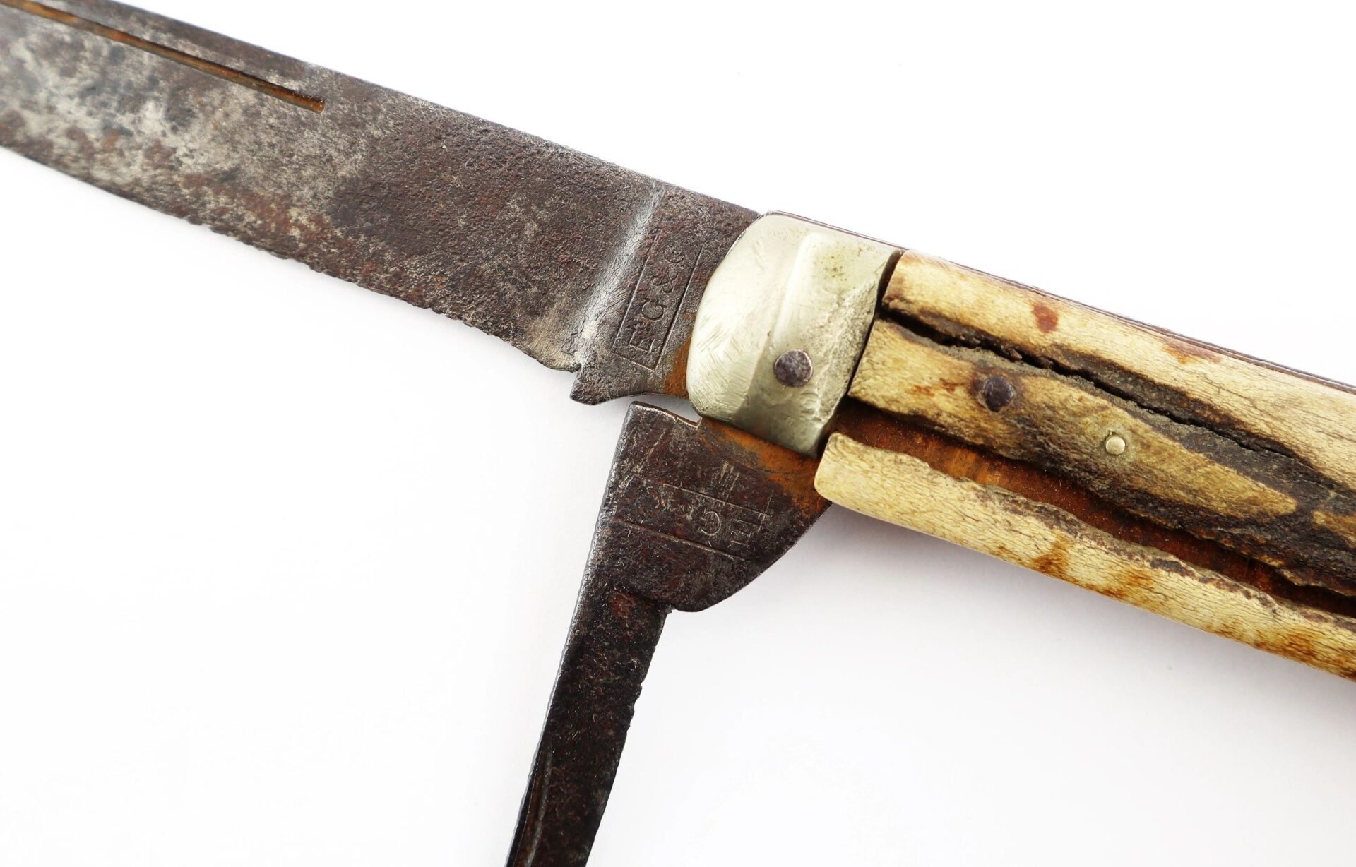Close-up of the John Hunt Morgan Knife and Grouping ID’d to Hiram T. Fisher, 16th Ohio and 53rd USCT, showing its rusted blade, metal and wood handle, and a partially unfolded secondary tool.