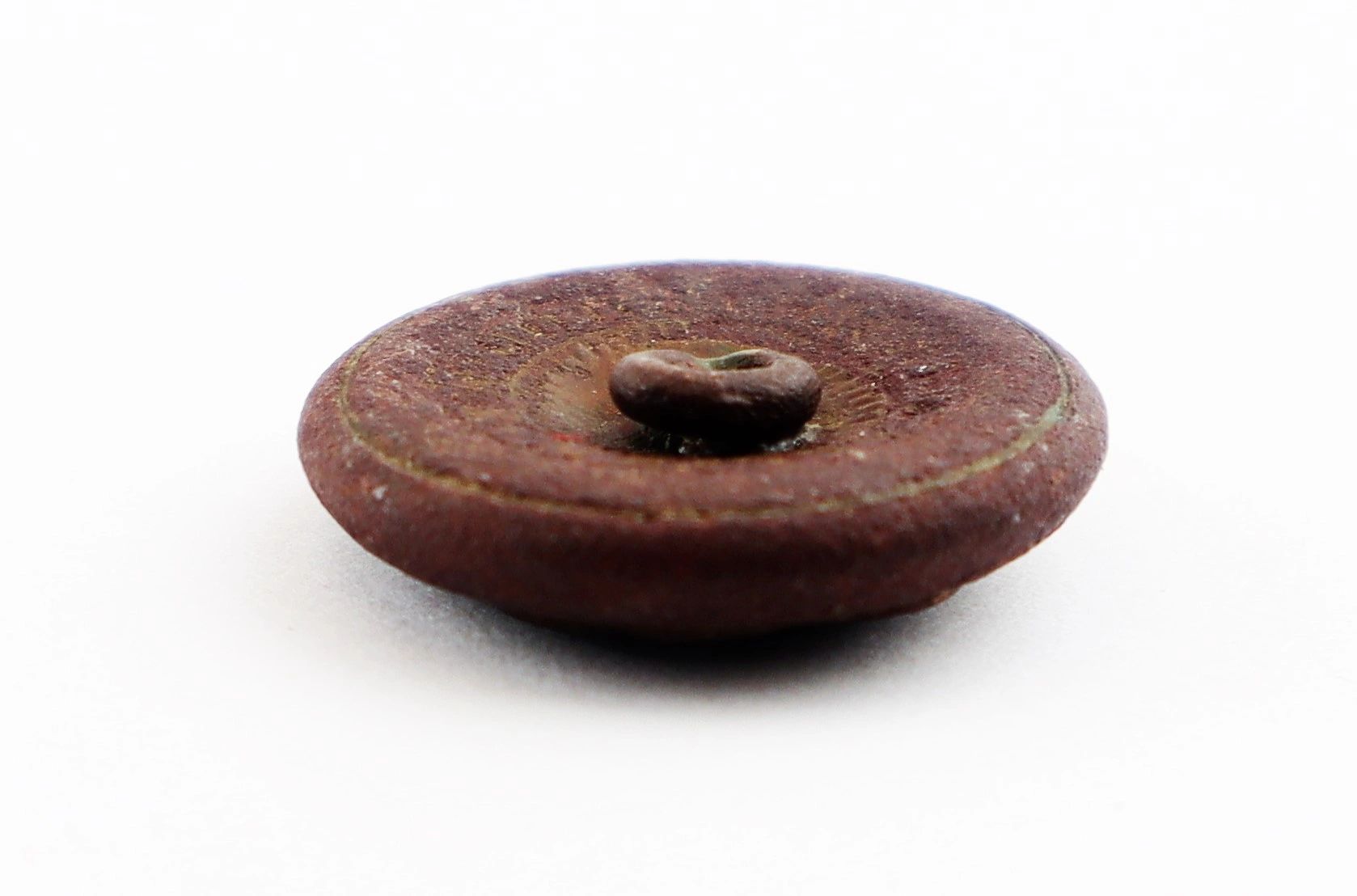 The South Carolina Coat Button - Battle of Gettysburg is shown lying flat on a white surface, viewed at an angle.