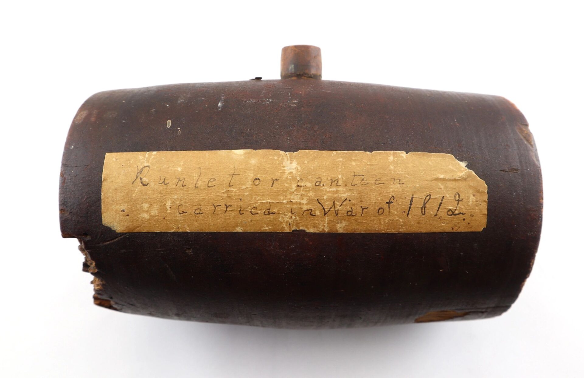 A small, cylindrical wooden War of 1812 Rundlet Canteen with a worn label. Sold.