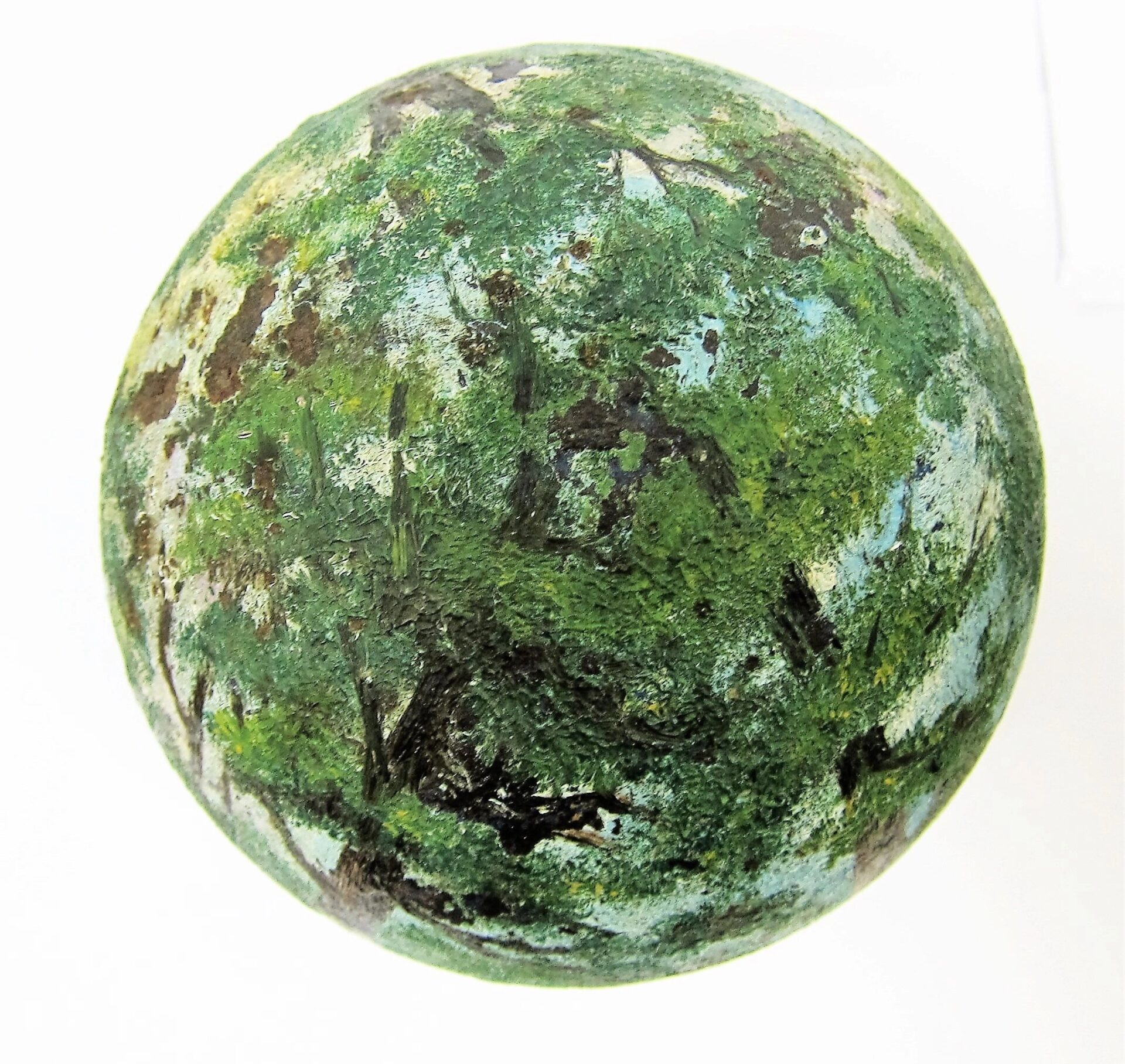 A Painted Cannon Ball with a mottled green, brown, and blue surface, resembling a small globe or moss-covered stone.