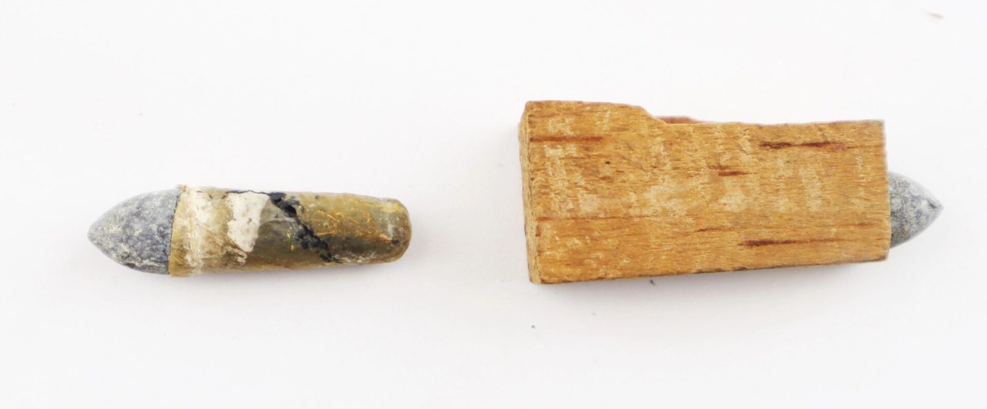 .36 Caliber Navy Cartridges / SOLD—two Civil War era bullets, one with its wooden plug attached and the other separated, displayed on a white background.
