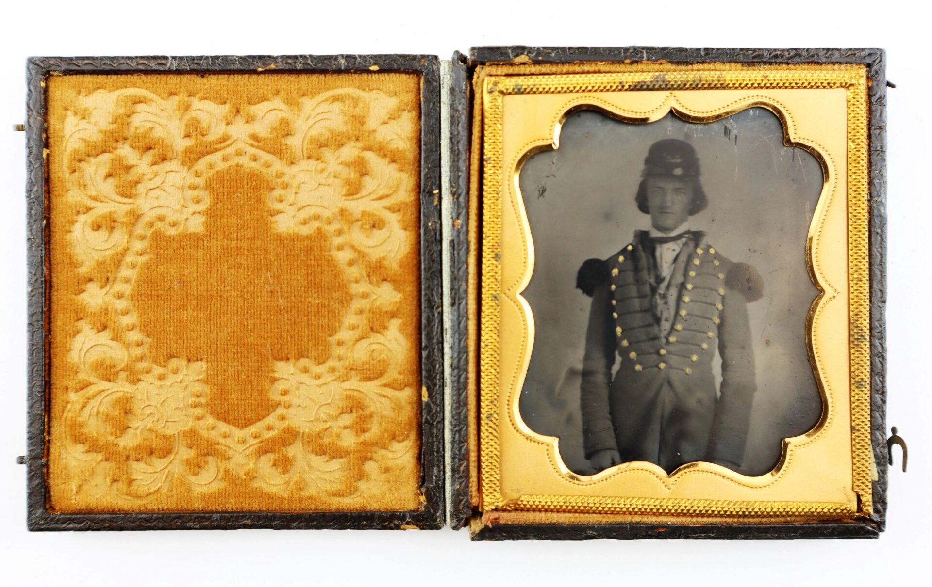 The 1/6 Plate Ambrotype of a Southern Militiaman features a vintage photo of a uniformed man with decorative buttons and a tall hat, displayed in an ornate case with embossed velvet lining on the left side.
