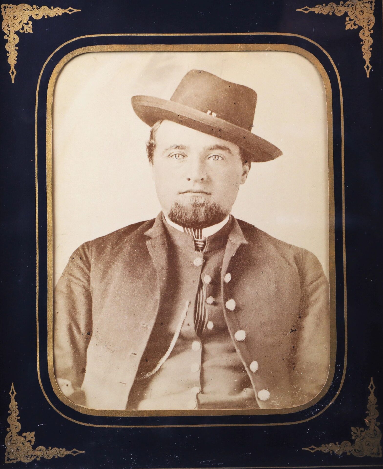 Albumen photograph of a Western Theater Union soldier in 19th-century attire—jacket, vest, and wide-brimmed hat—set in a decorative frame.