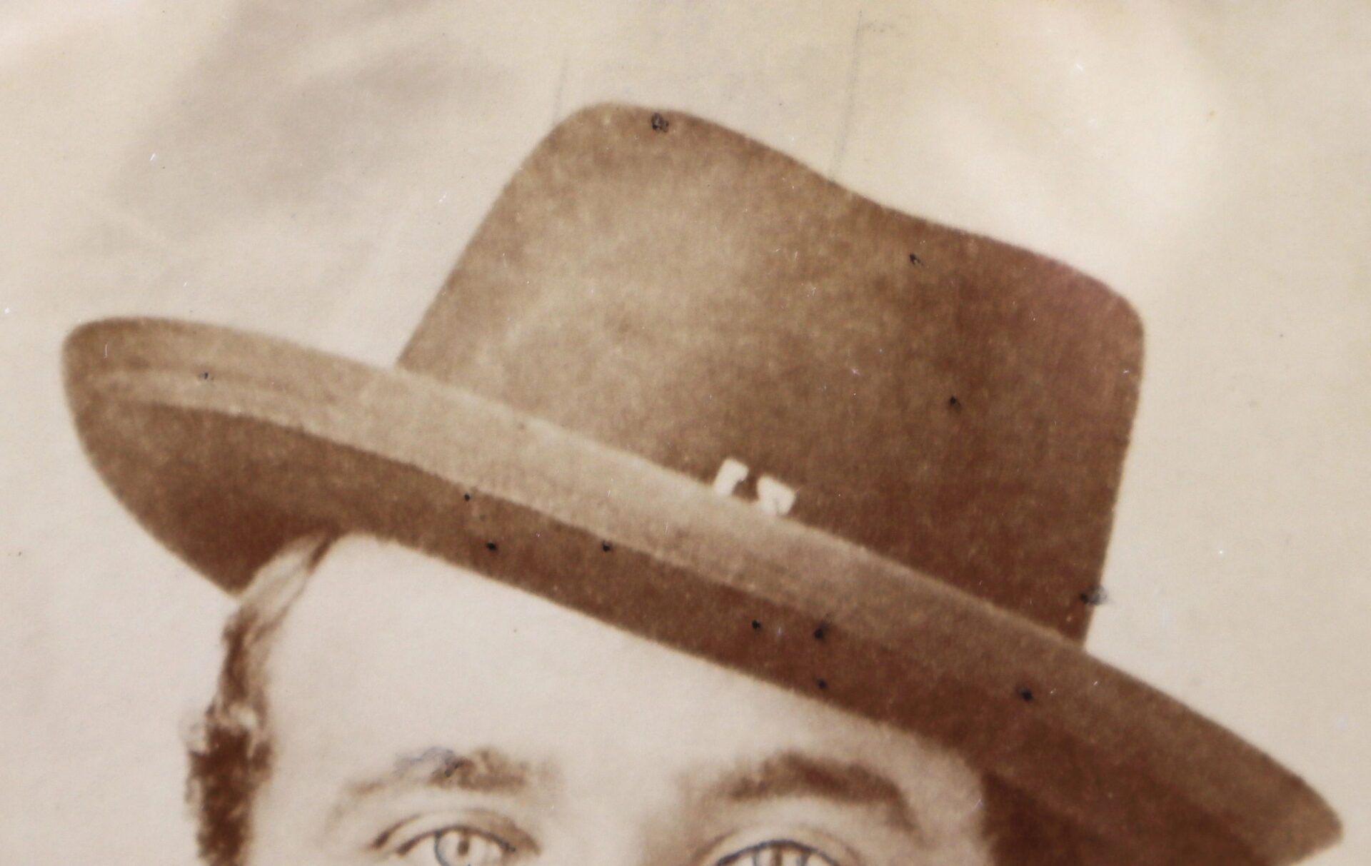 Sepia-toned close-up of a Western Theater Union Soldier’s face in an albumen photograph, showing only the eyes and forehead beneath a wide-brimmed hat.