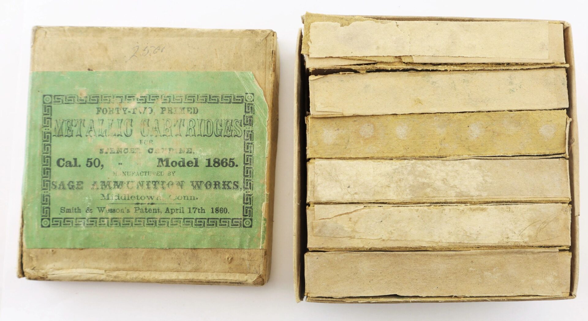 A complete box of 1865 Spencer cartridges, featuring a green “Metallic Cartridges, Cal. 50, Model 1865” label and original stacked cartridges inside.