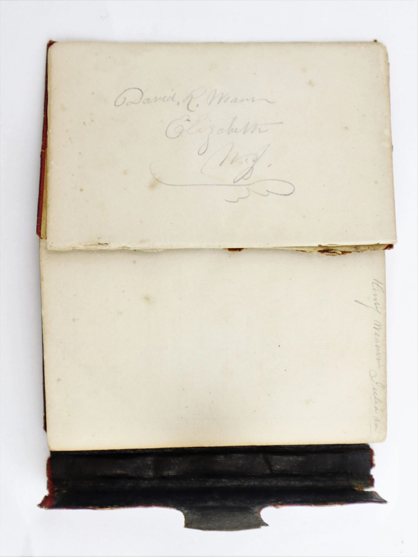 An open book titled "Discharges, Bible, and Reunion Ribbons of David R. Weaver 30th New Jersey Infantry and Battery D, 1st NJ Light Artillery / SOLD" with handwritten names is shown from above; the book has a dark cover.