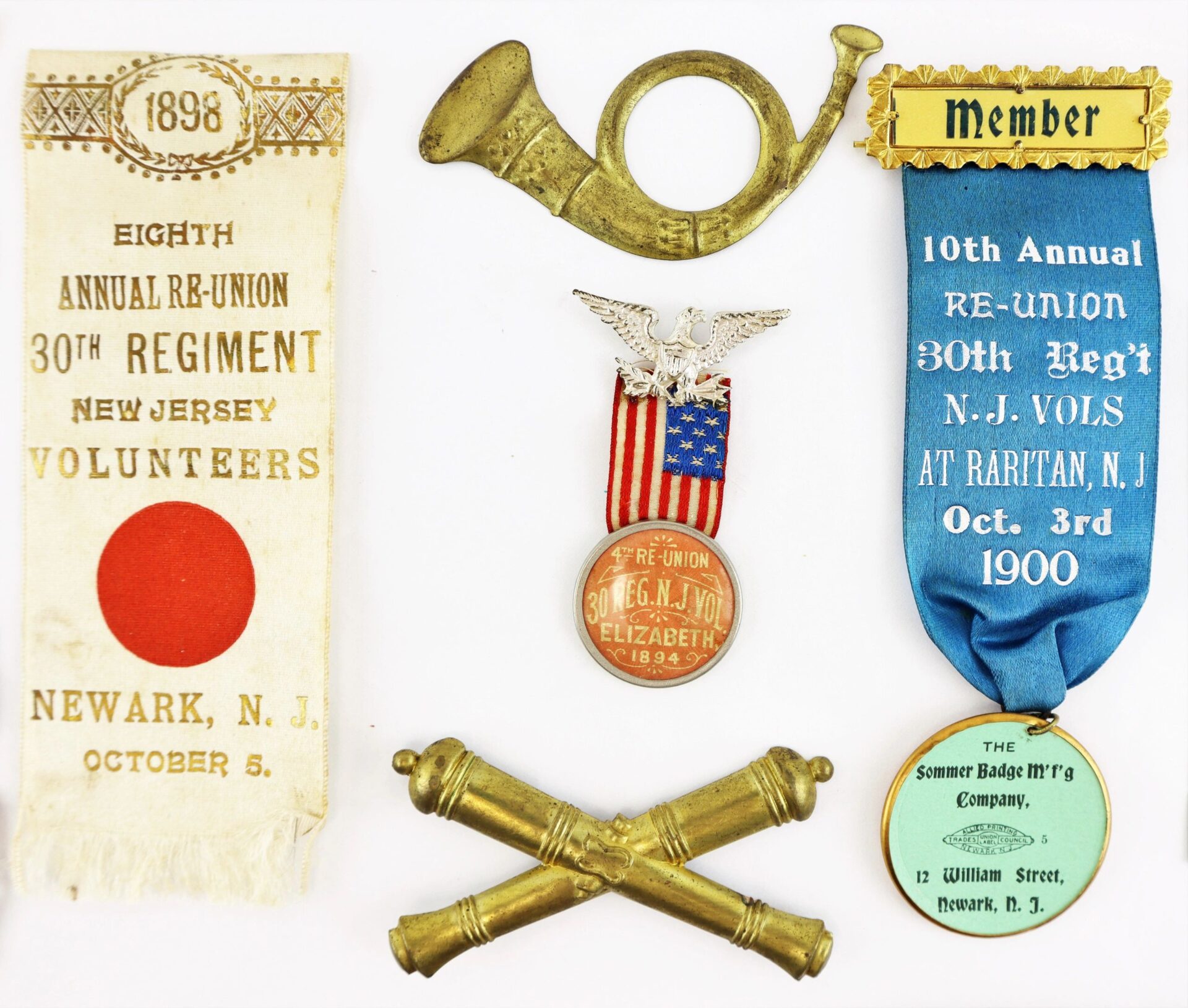 A collection of discharge papers, Bible, and reunion ribbons belonging to David R. Weaver of the 30th NJ Infantry and Battery D, 1st NJ Light Artillery, is displayed on a white background.