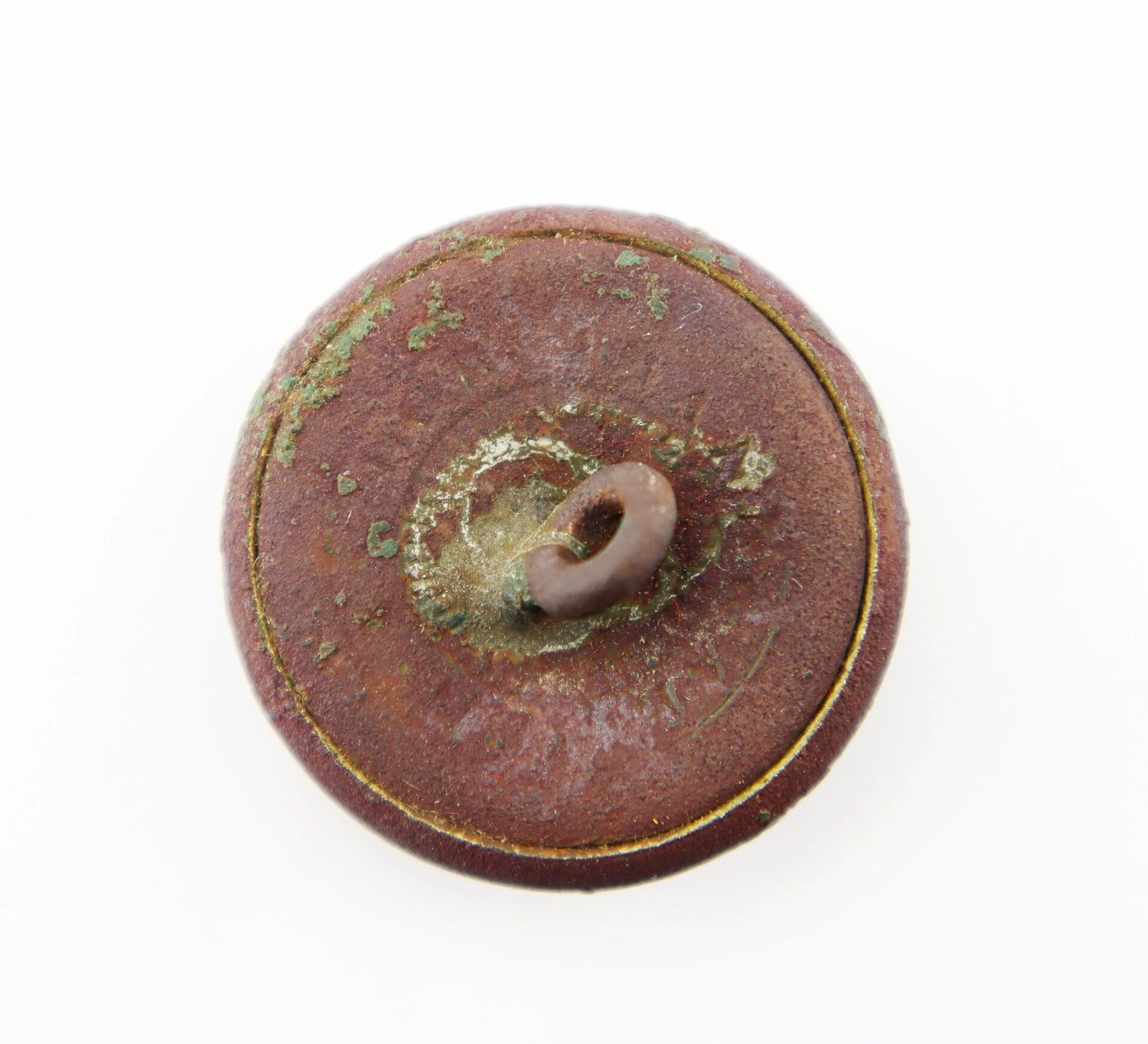 The South Carolina Coat Button is a round metal button featuring a loop shank on the back, with visible rust, corrosion, and greenish oxidation.