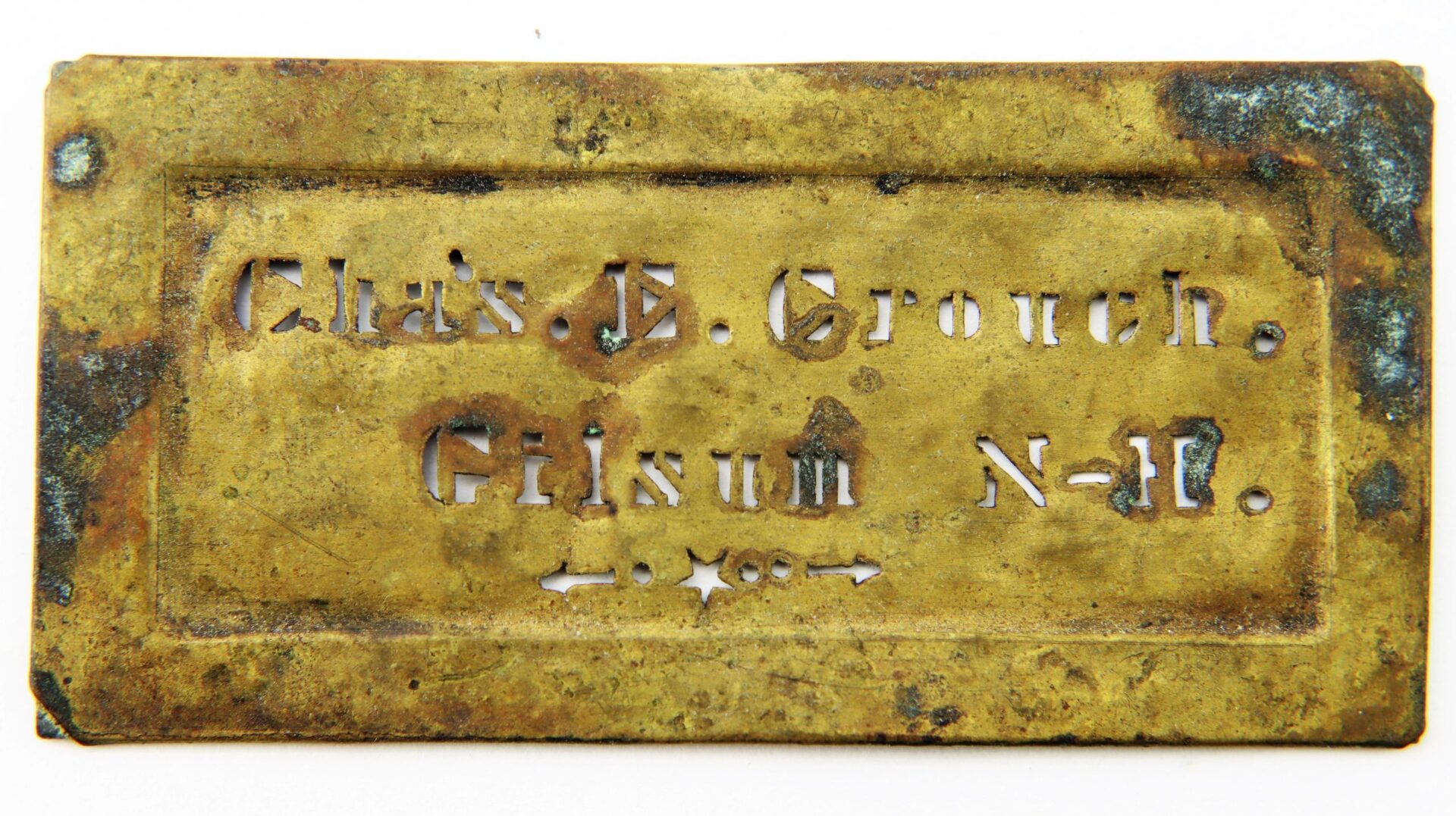 A rectangular, weathered brass nameplate stenciled with "Charles E. Crouch, 9th New Hampshire Infantry" identifies it as an Identification Stencil.