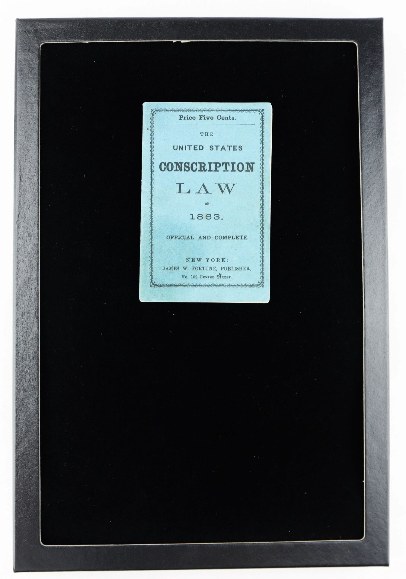 A framed display featuring a blue pamphlet, "The United States Conscription Law of 1863 Official and Complete," which enabled colored men to enlist in the war effort.