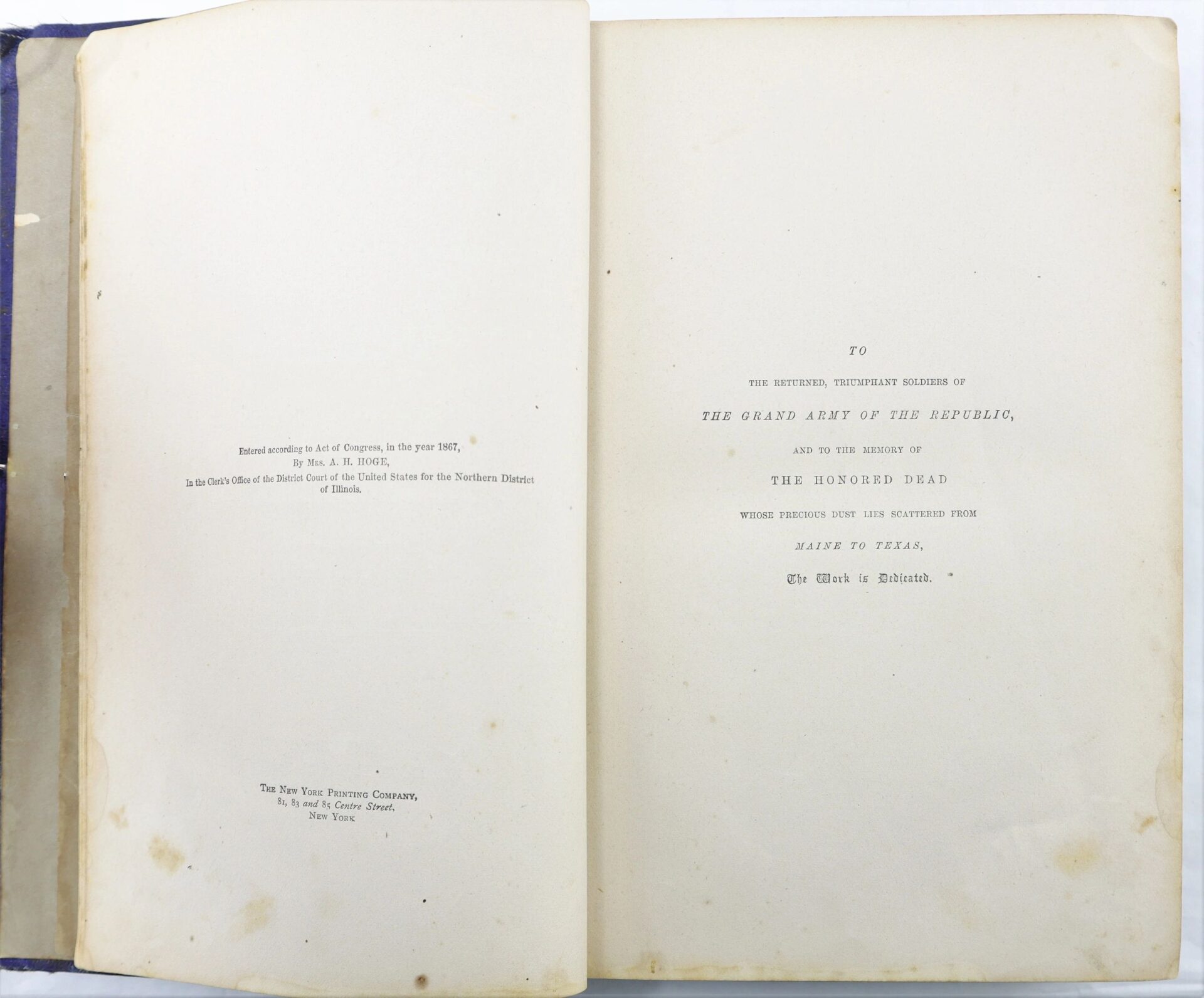Open book of "The Boys in Blue by A. H. Hoge / SOLD" displaying a dedication page honoring the Grand Army of the Republic and the fallen, with publishing details on the left page.