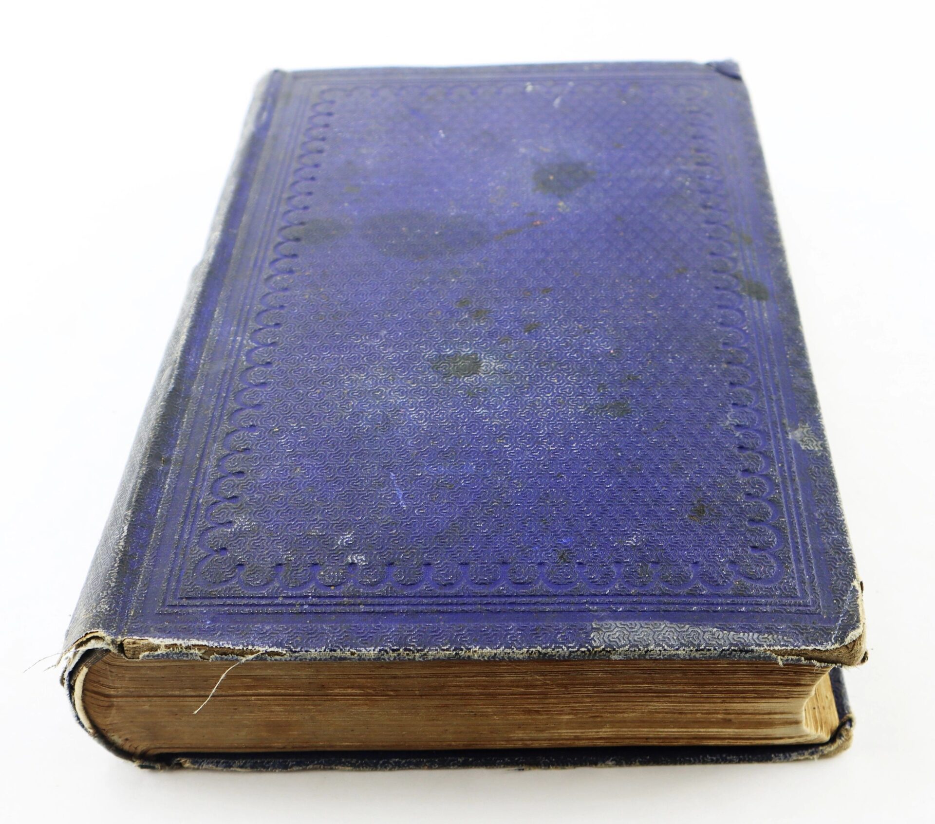 A vintage copy of "The Boys in Blue" by A. H. Hoge with a textured dark blue cover, gold-edged pages, and visible signs of age and staining. SOLD.