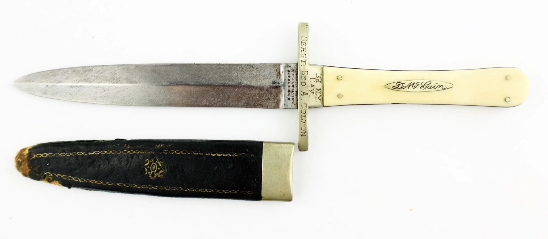 The Sheffield Dagger, picked up at Tranter’s Creek, NC by Sgt. George A. Colton of the 3rd NY Cavalry/SOD, features an ivory-colored handle and engraved blade with its black and gold sheath.