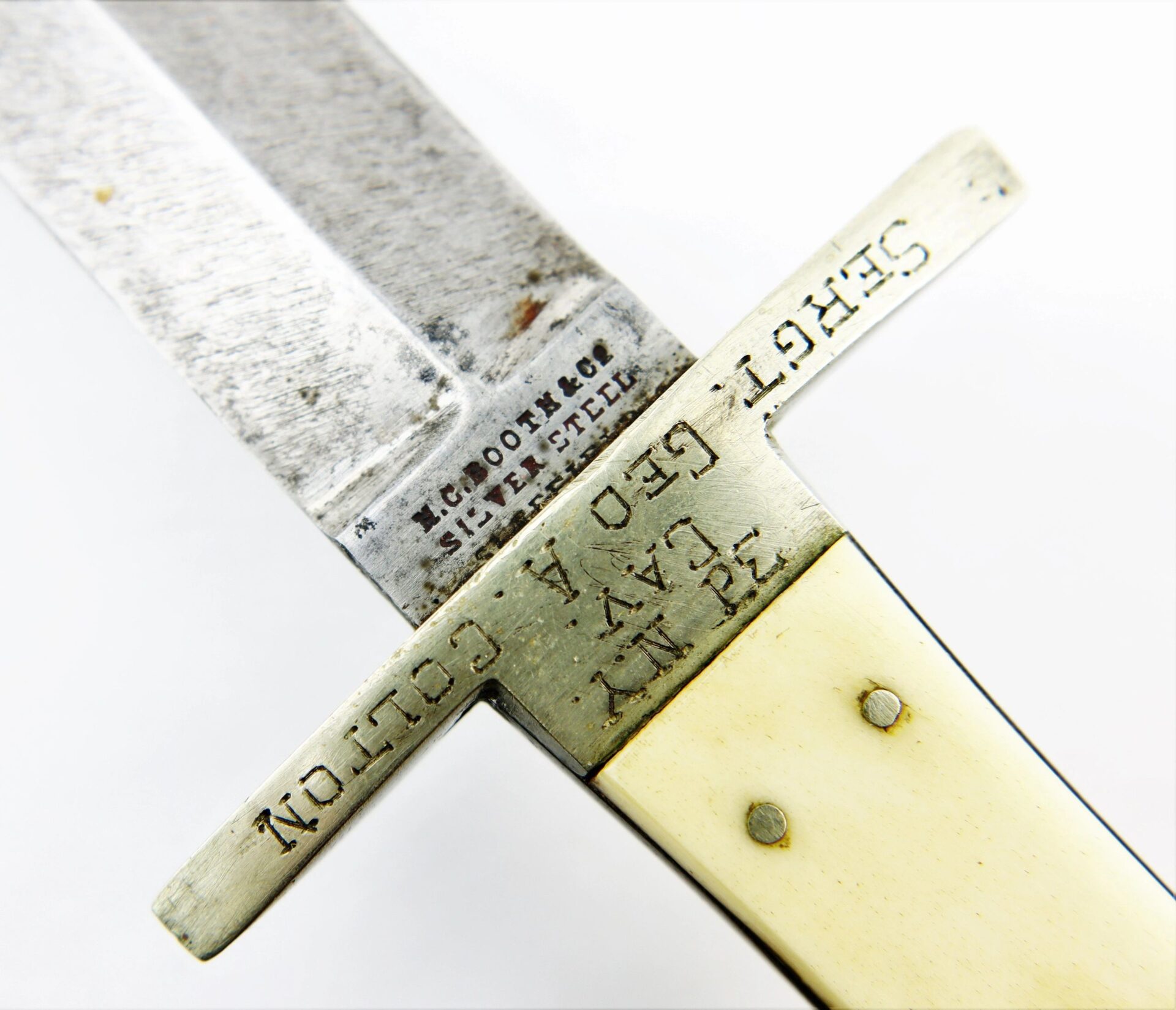 Close-up of the Sheffield Dagger, picked up at Tranter’s Creek, North Carolina by Sgt. George A. Colton, 3rd NY Cavalry/SOD—features a metal guard and worn ivory-colored handle with two rivets.