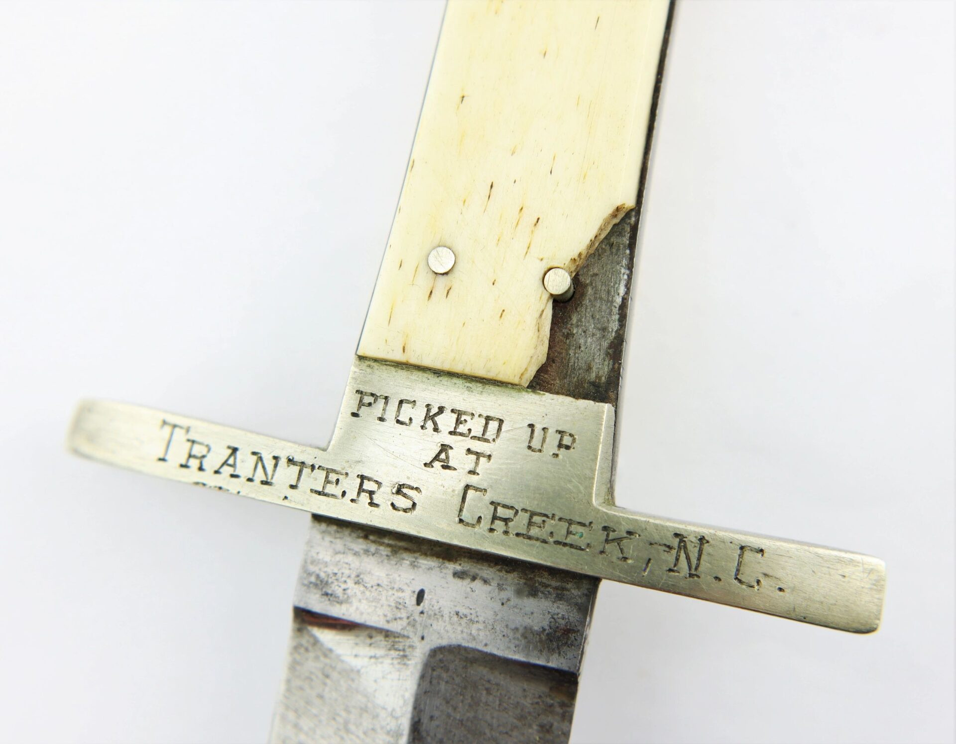 Close-up of the Sheffield Dagger picked up at Tranter’s Creek, NC by Sgt. George A. Colton, 3rd NY Cavalry/SOD, showing an inscription on the metal guard: "PICKED UP AT TRANTERS CREEK, N.C.