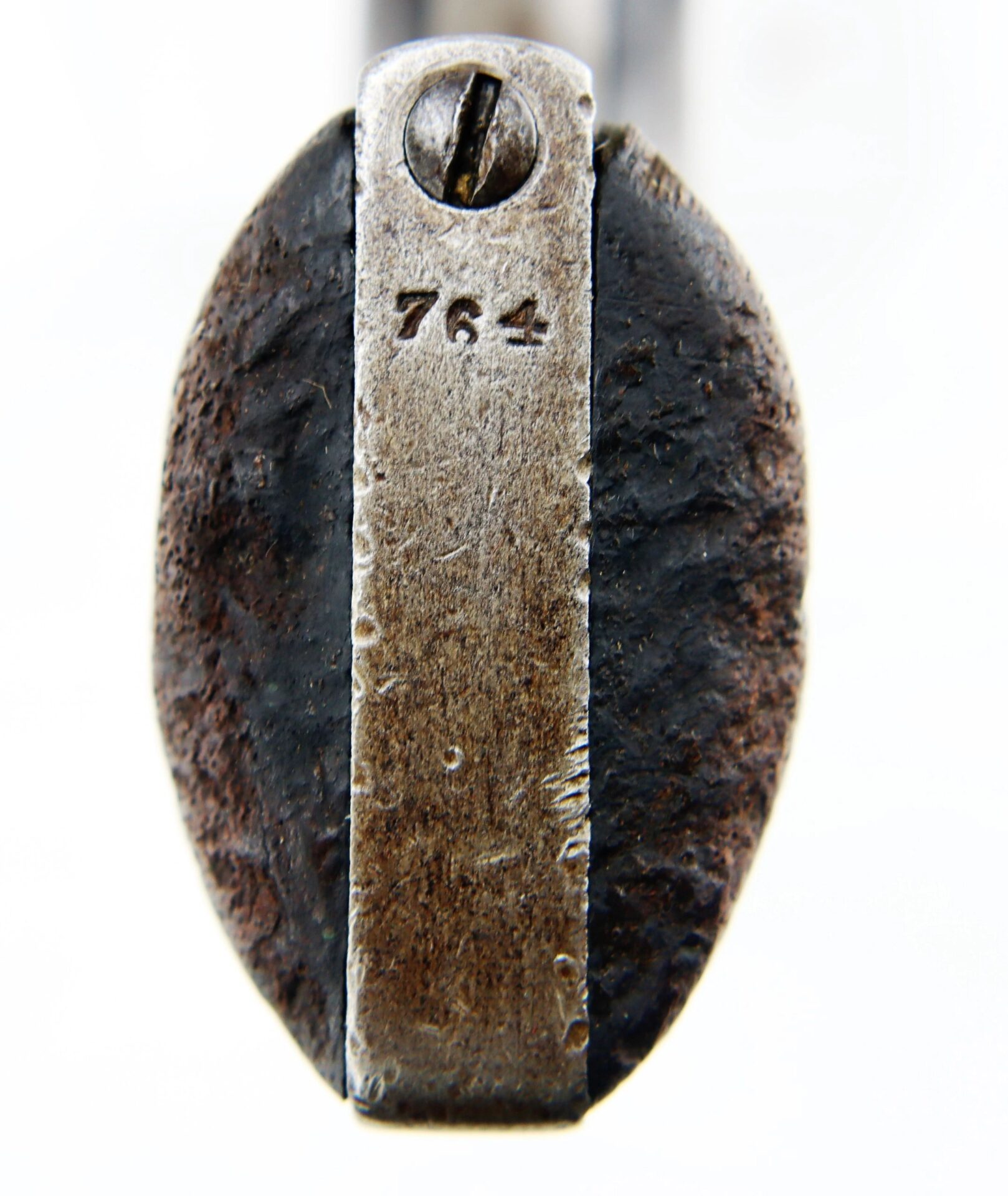 Close-up of a J. M. Cooper Pocket Model Revolver (SOLD), showing a screw at the top and "764" engraved below; sides display rust and wear.