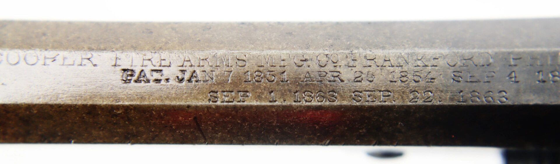 Close-up of engraved patent dates (1851, 1854, 1856, and 1866) on the metal barrel of a J. M. Cooper Pocket Model Revolver / SOLD.