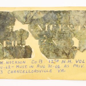 A damaged Civil War Soldier’s Stencil, used for identification, marked "H. NICKSON CO B 2N" and recovered from Chancellorsville, is mounted on yellow paper with handwritten service details below.