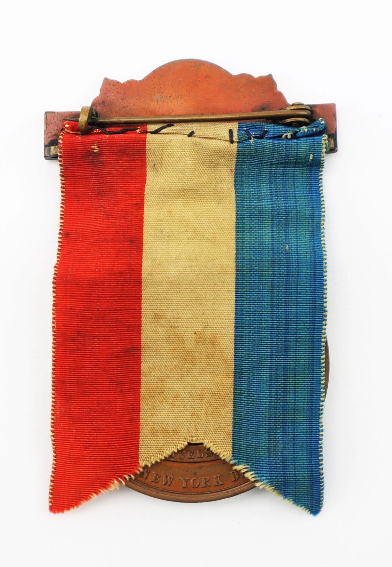 The Gettysburg New York Day Medal, inscribed to Private Hugh McDonald, 40th New York Infantry “Mozart Regiment,” features a vertical red, white, and blue ribbon with a bronze-colored clasp and engraved plate.