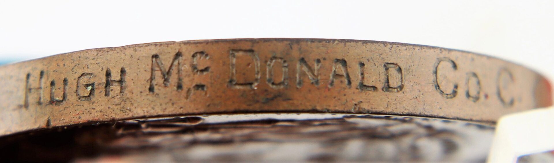Close-up of the Gettysburg New York Day Medal inscribed to Private Hugh McDonald, 40th New York Infantry “Mozart Regiment,” with “HUGH MC DONALD CO. C.” engraved along its edge.