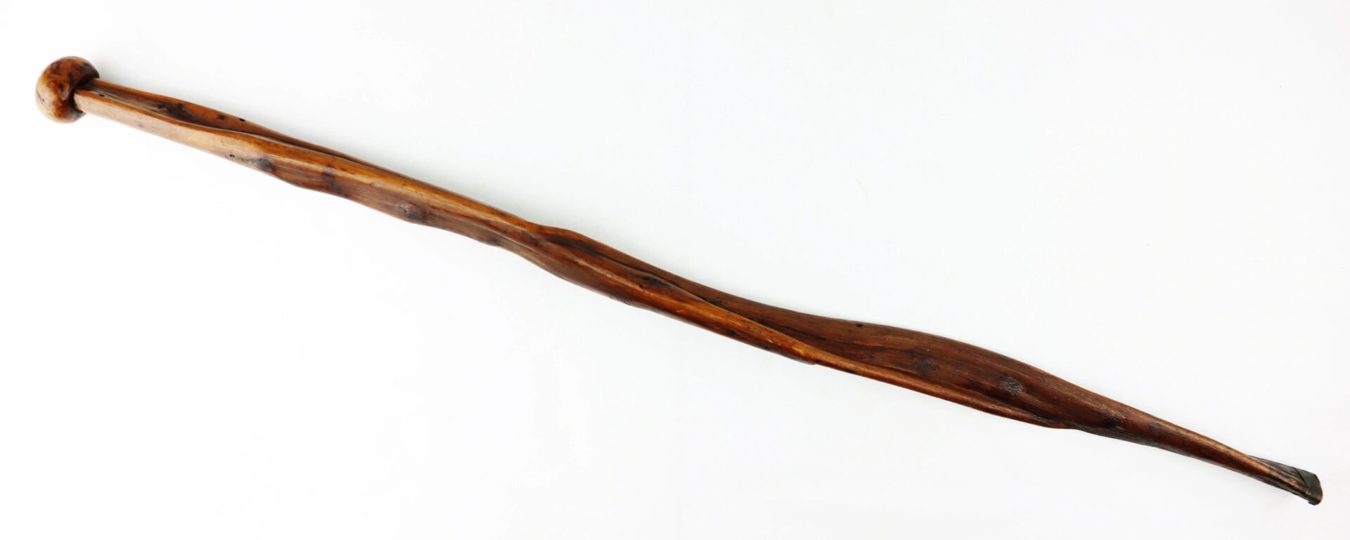 A Cane Made of Wood from Georgia Swamp, featuring a natural, uneven shape with a slight twist and rounded end, shown against a white background.