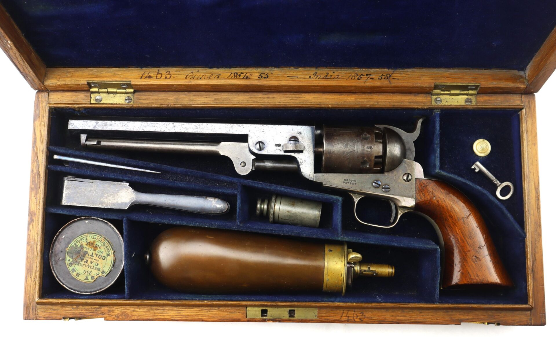 Cased High Condition London Colt 1851 Navy Percussion Revolver in a blue-lined wooden case, includes revolver, powder flask, bullets, key, and accessories.